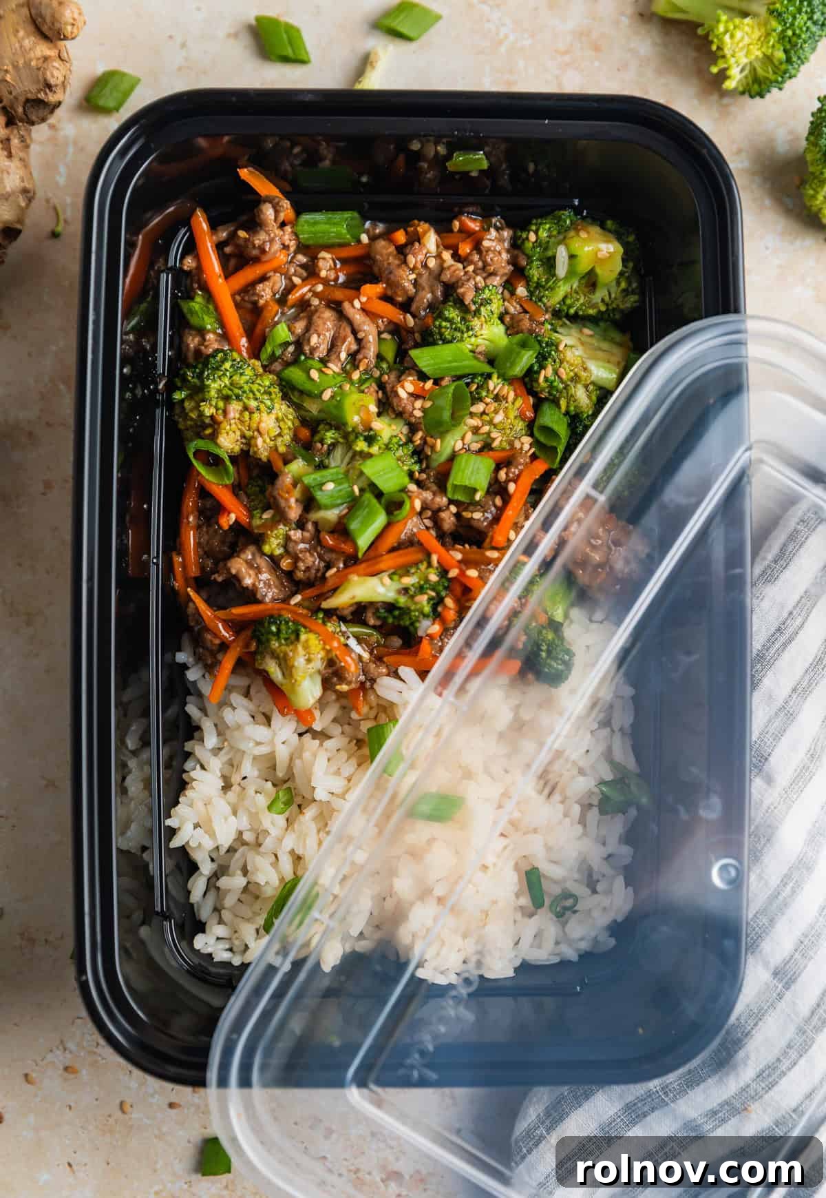 Sticky Teriyaki Ground Beef 3 Meal prep container with rice and ground beef teriyaki with lid slightly covering it.