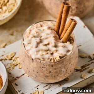 Overnight oats with cinnamon roll flavor in jar with icing drizzled over top.
