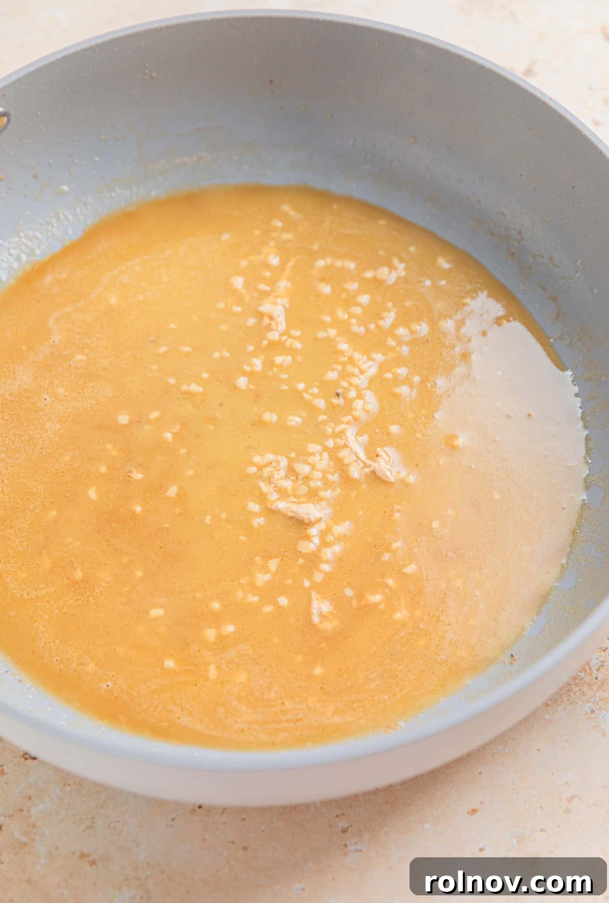 Butter, garlic and broth melted in skillet.