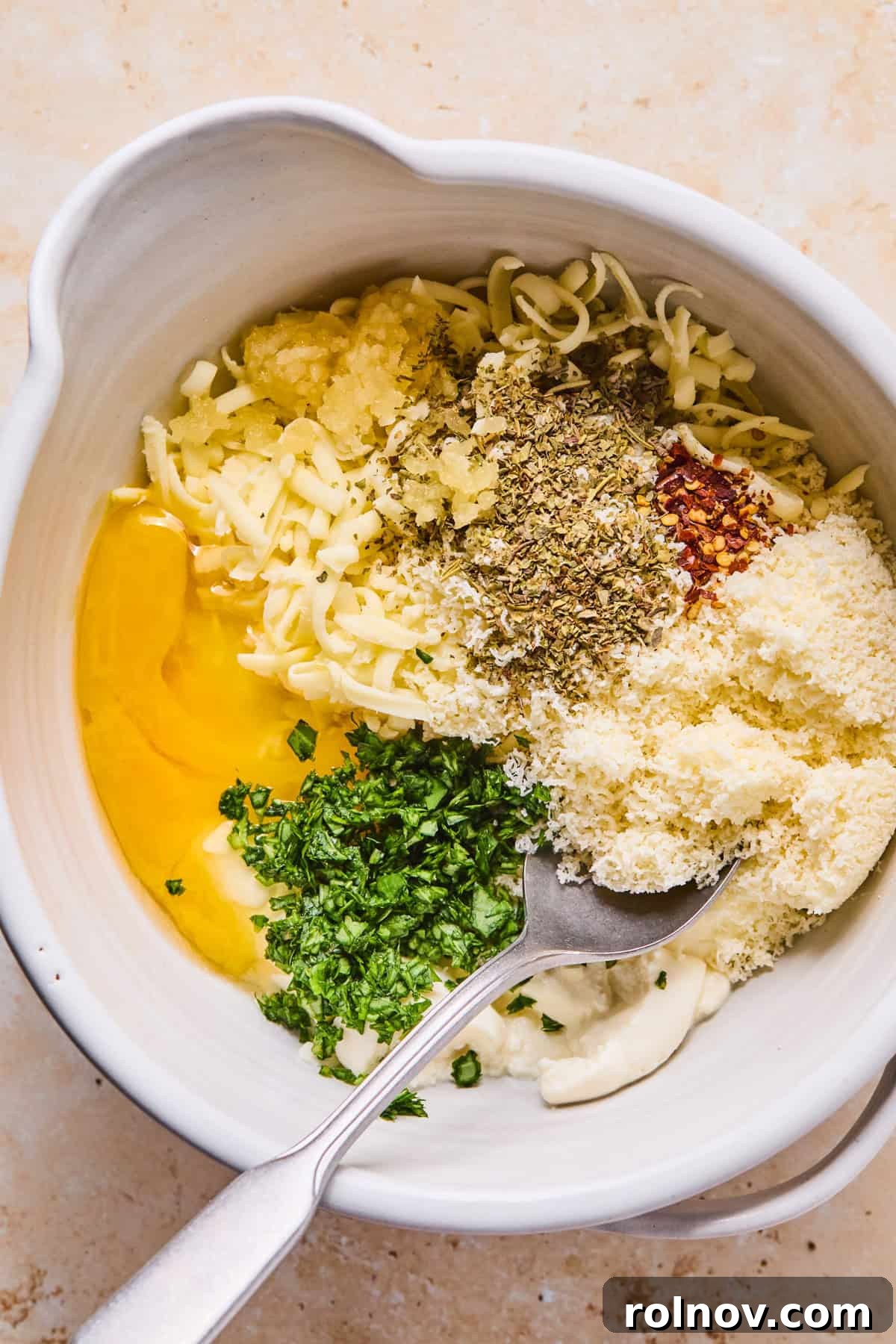 Rustic Italian Sausage Pasta Casserole 7 Mixing bowl with egg, ricotta and other ingredients.