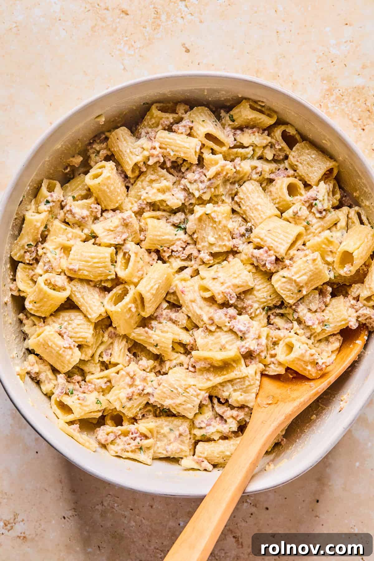 Rustic Italian Sausage Pasta Casserole 9 Meat and pasta added to cheese mixture in bowl.