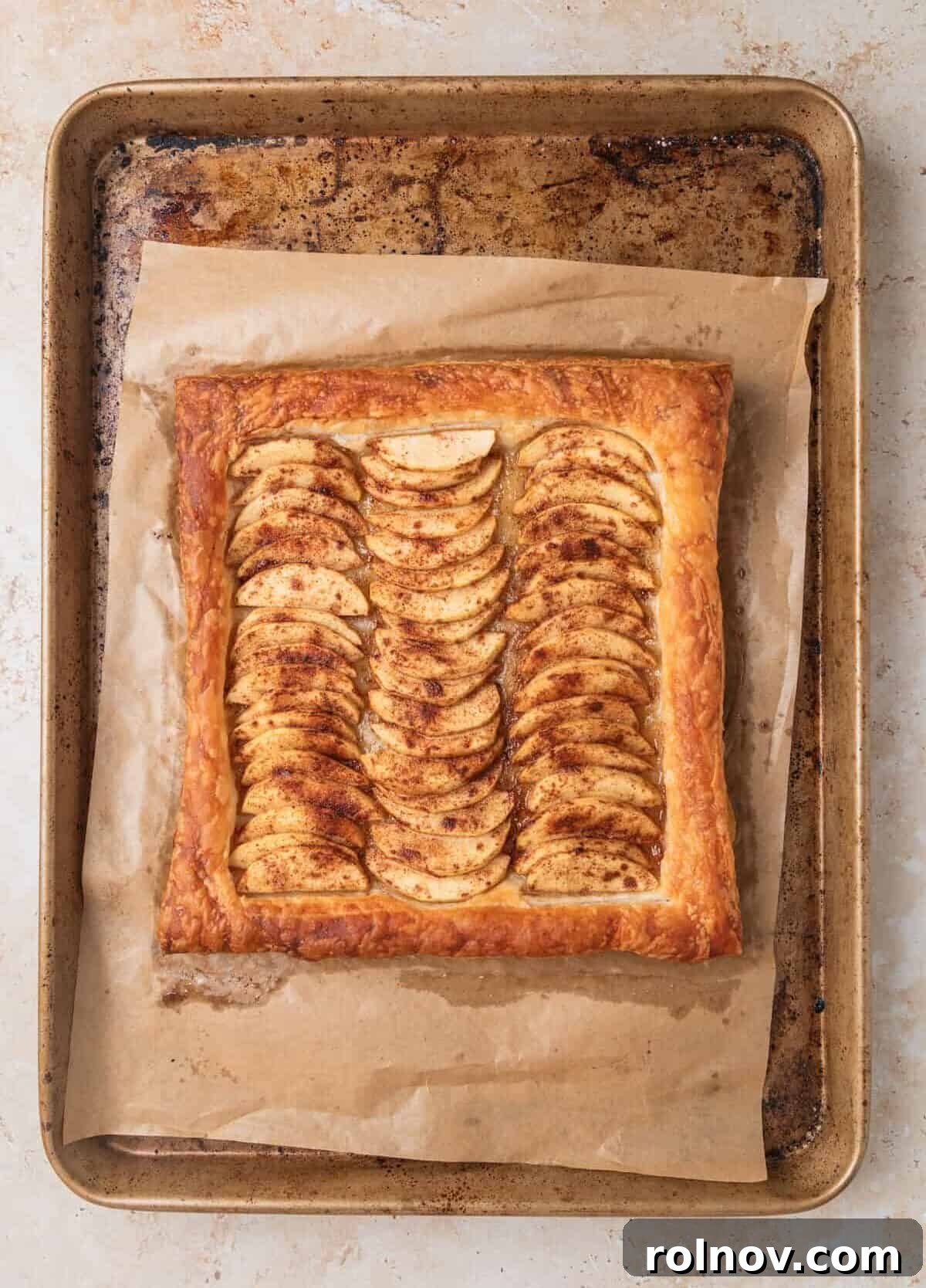 Flaky Apple Delight 7 Baked apple and puff pastry tart on baking sheet after baking.