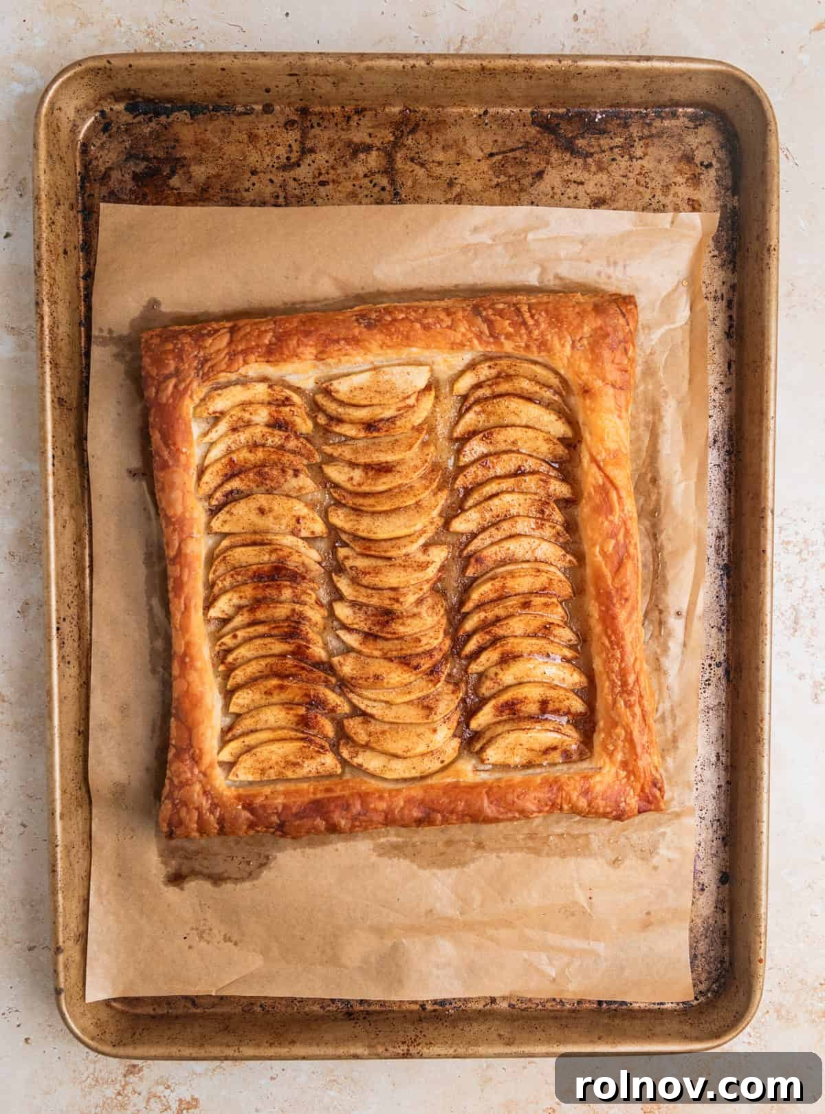Flaky Apple Delight 8 Apple tart baked with honey brushed to glaze the apples on baking sheet.