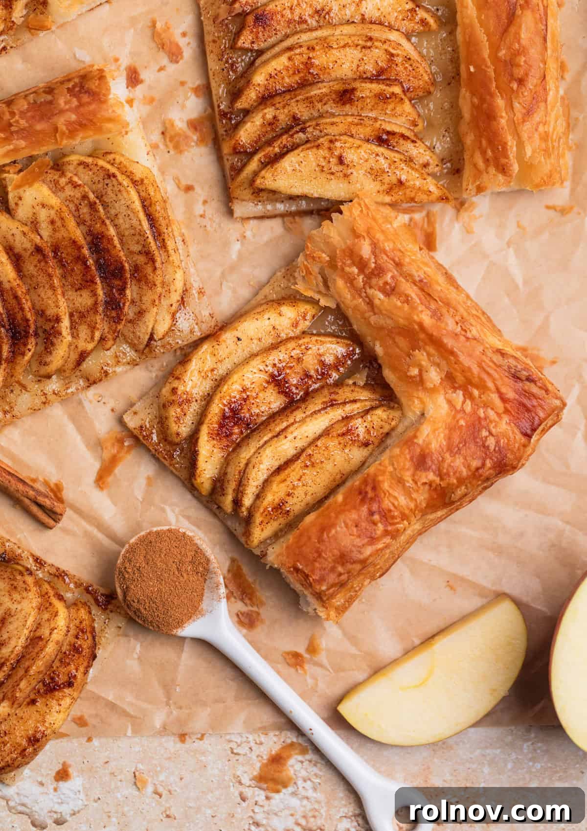 Flaky Apple Delight 9 Puff pastry cinnamon apple tarts arranged on parchment.