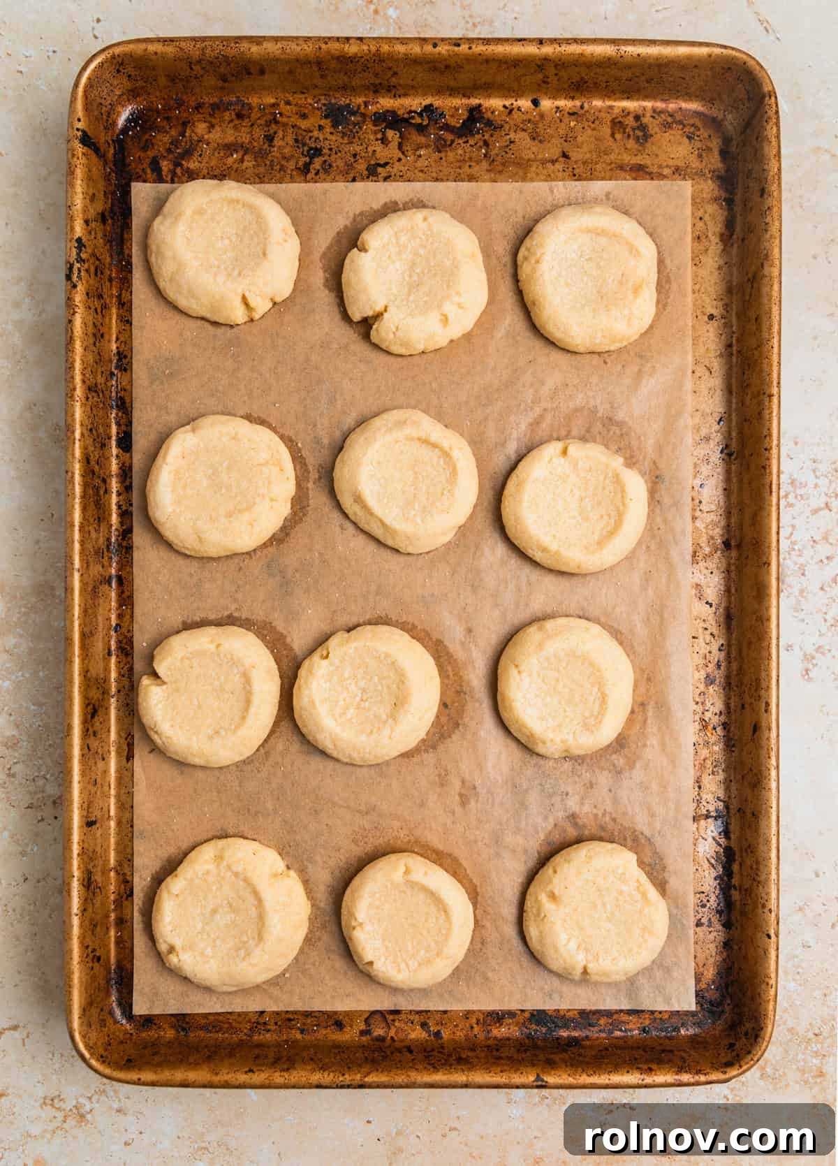 Irresistible Nutella Thumbprints 11 Baked thumbprint cookies on pan.