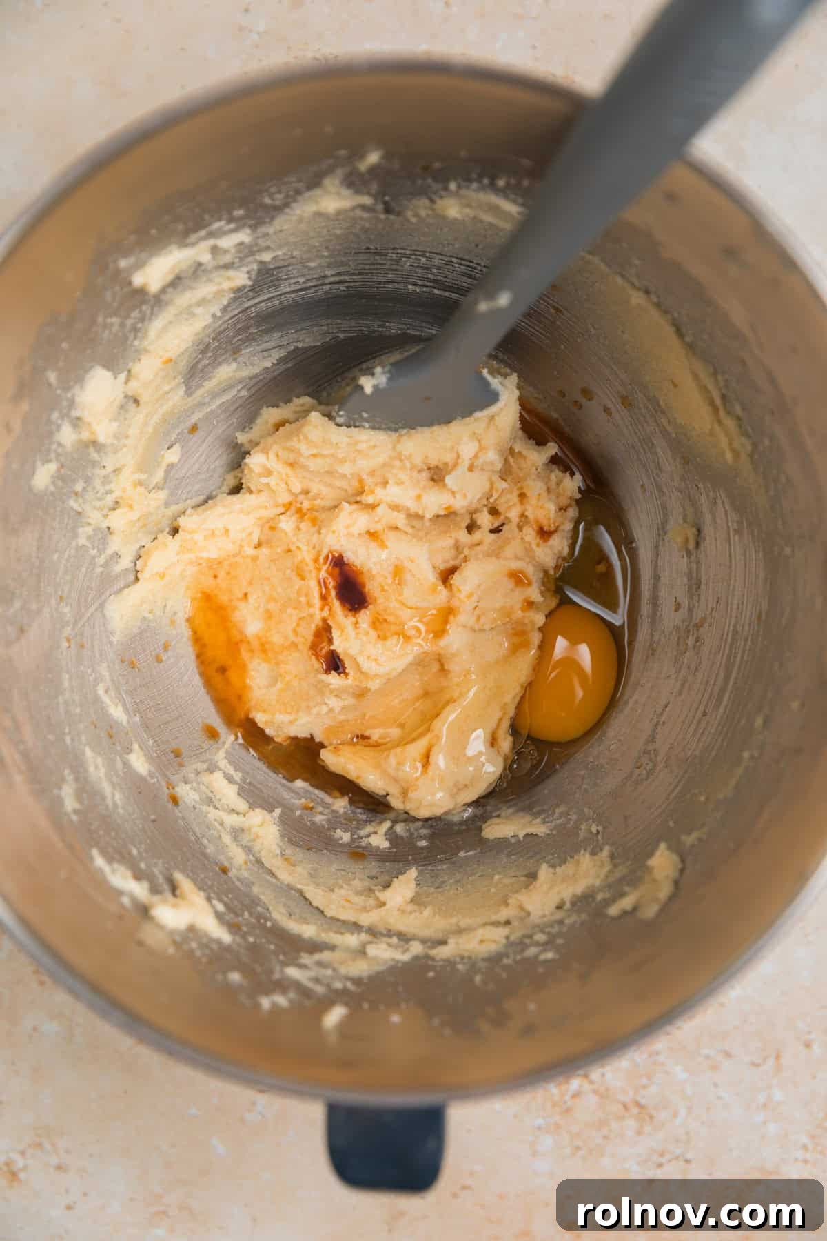 Irresistible Nutella Thumbprints 5 Egg and vanilla added to creamed butter and sugar in bowl before mixing.