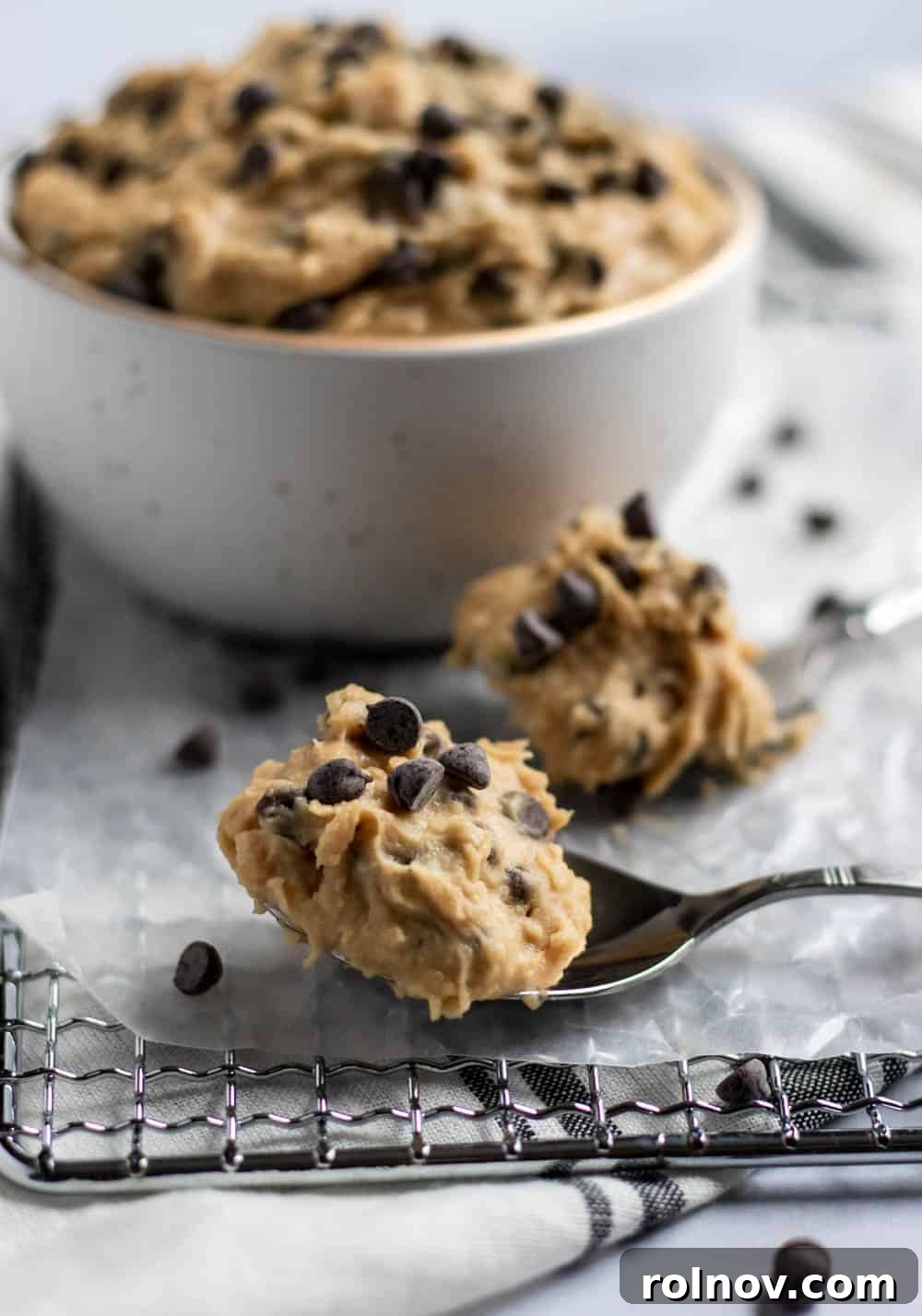 Secret Ingredient Cookie Dough Delight 4 cookie dough on spoons in front of bowl.