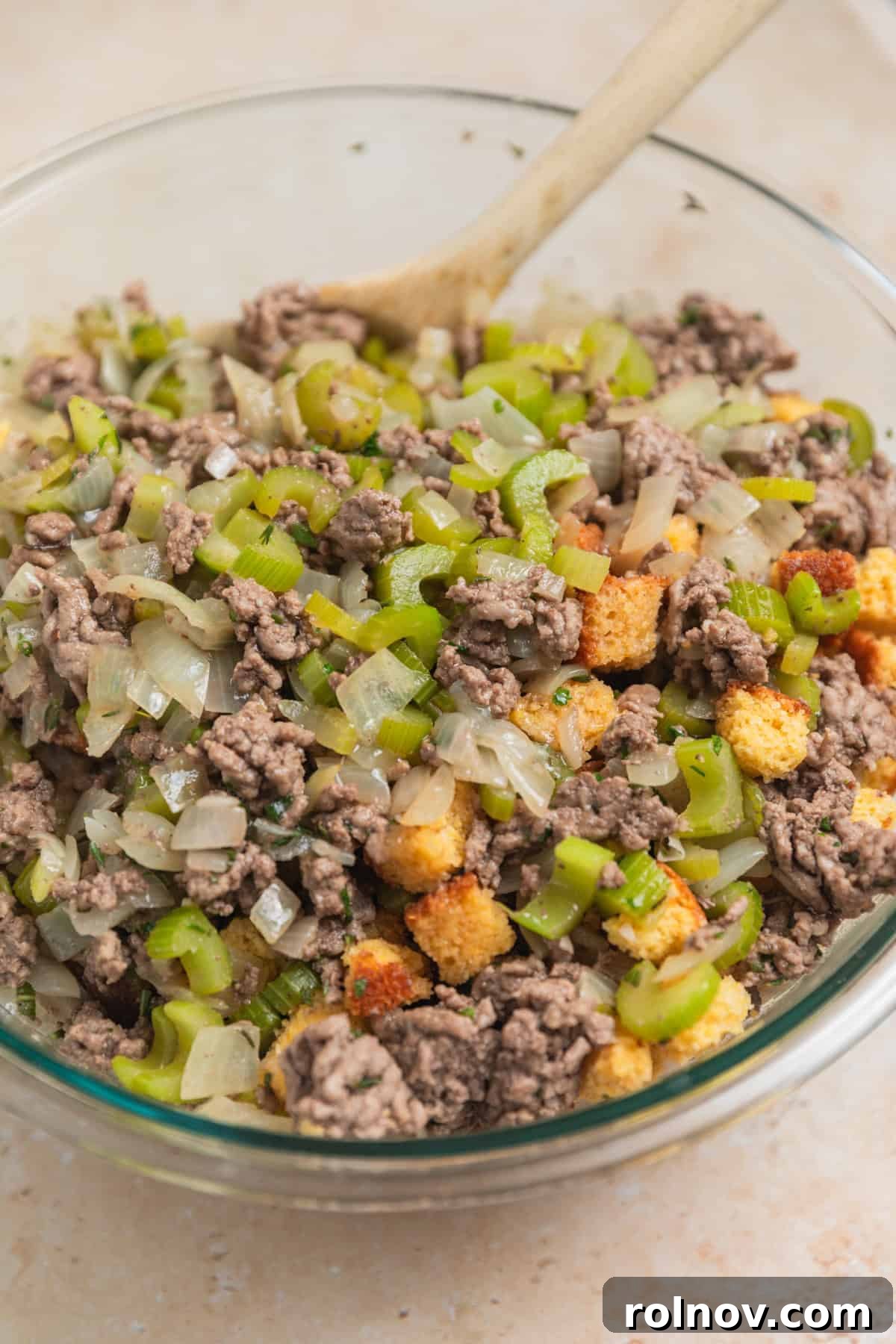 Southern Beef Cornbread Dressing 8 Beef and vegetable mixture in bowl with cornbread cubes.