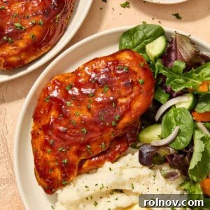 Air fryer barbecue chicken breast on plate with sides.