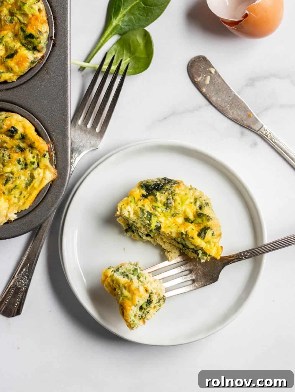 Spinach Egg Power Bites 3 Close-up of freshly baked spinach and zucchini egg muffins in a muffin tin