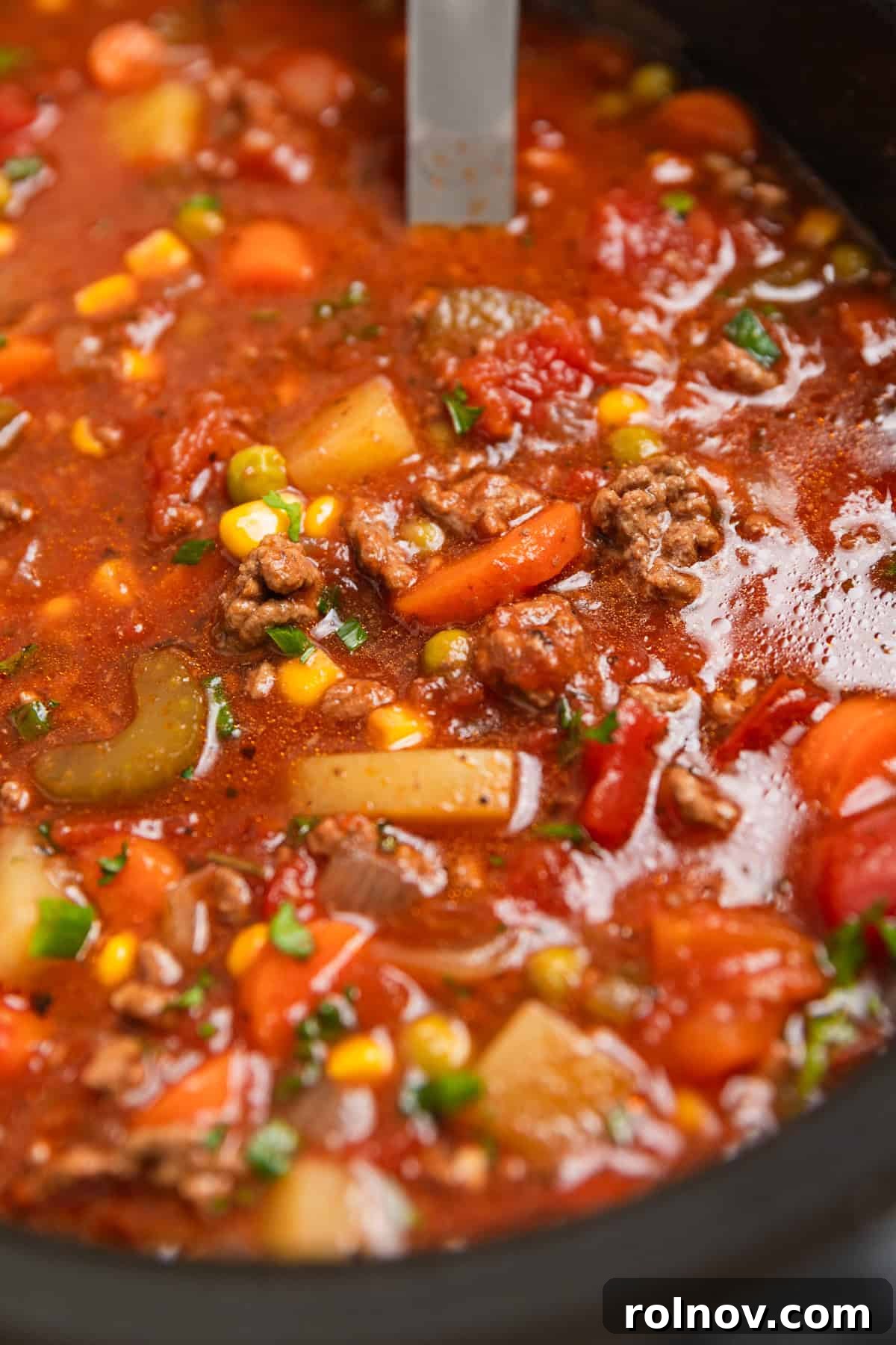 Hearty Slow Cooker Ground Beef Soup 2 Hearty Crock Pot Hamburger and Vegetable Soup with a ladle scooping into the pot, steam rising.