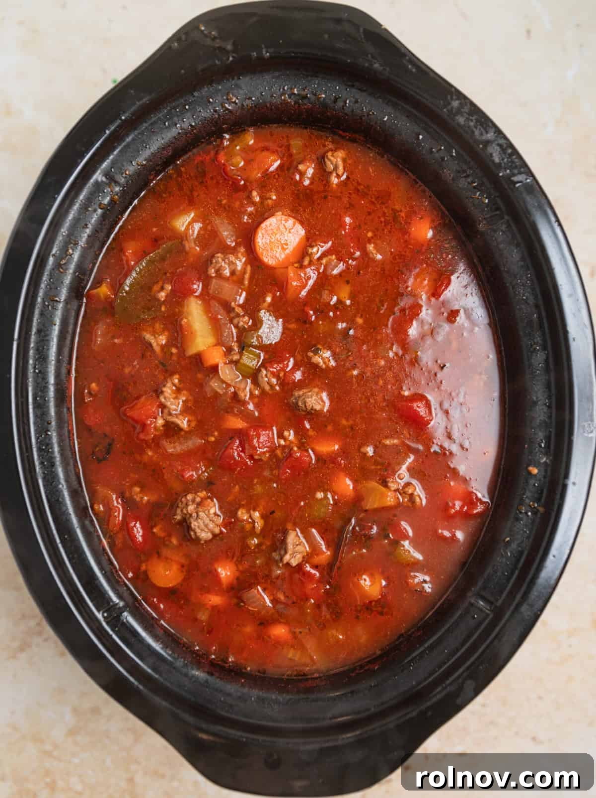 Hearty Slow Cooker Ground Beef Soup 7 Slow cooked hamburger soup simmering in crockpot before final additions.