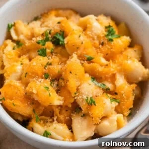 Bowl with protein mac and cheese with chopped parsley over top.