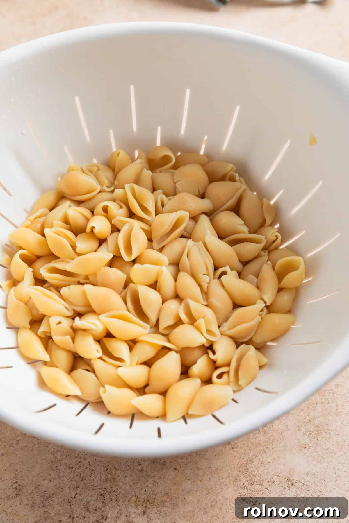 Muscle Mac 4 Protein pasta in a colander after being cooked to al dente, showing its firm texture.