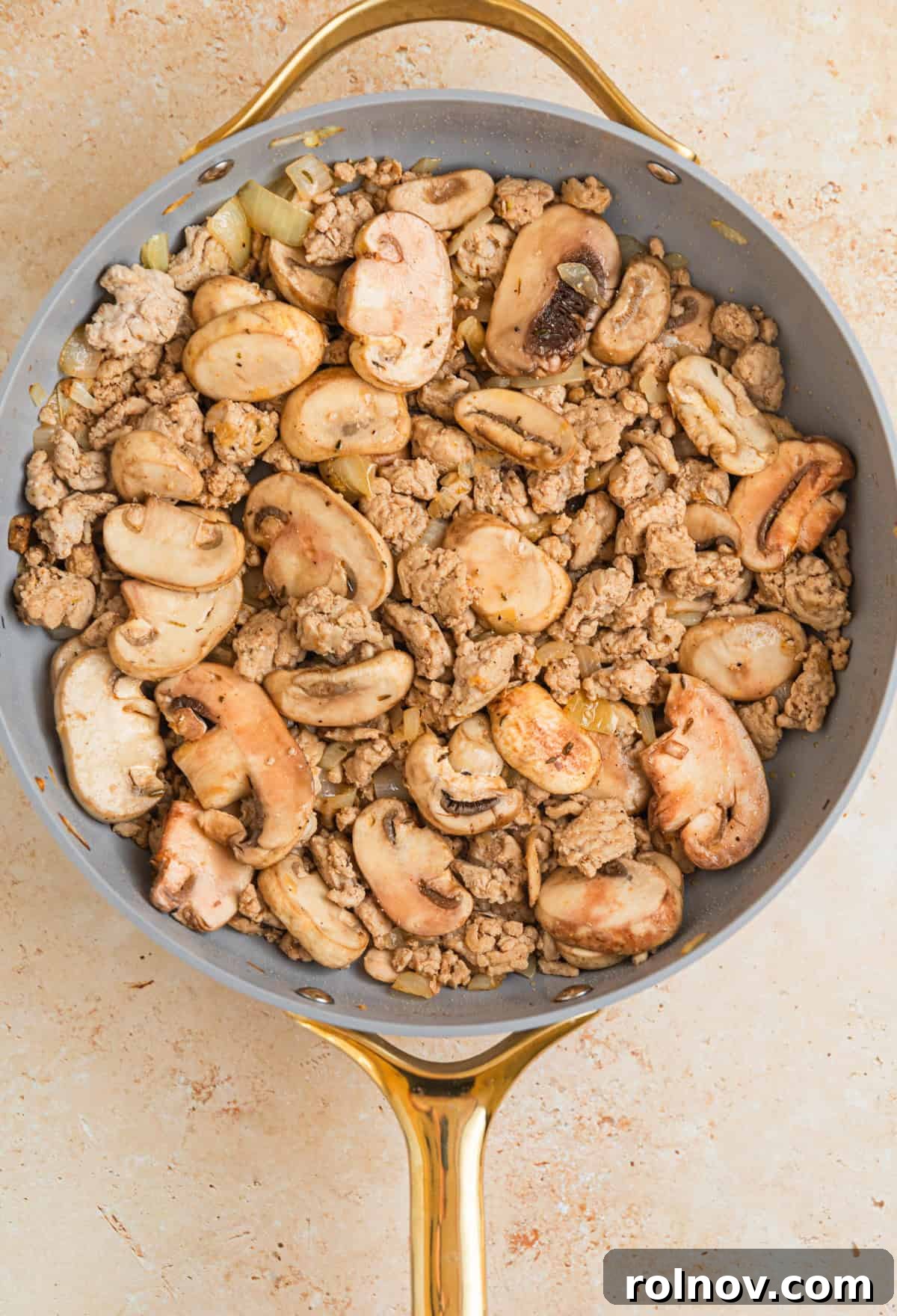 Creamy Ground Turkey Stroganoff 6 Mushrooms in skillet with browned ground turkey and onions.