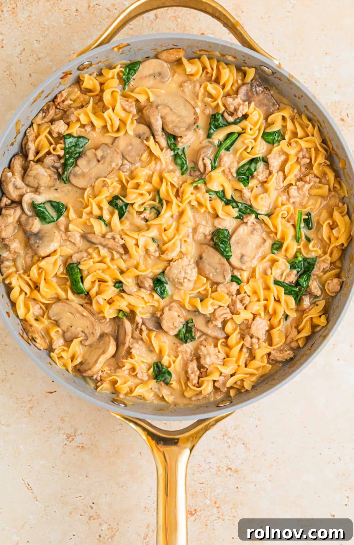 Creamy Ground Turkey Stroganoff 9 Cream cheese, sour cream and spinach added to skillet with turkey stroganoff ingredients.