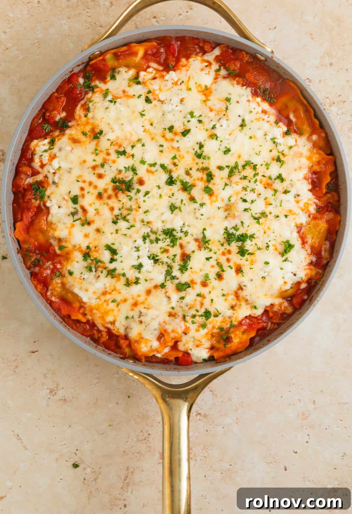 One-Pan Ravioli Lasagna 11 Skillet ravioli lasagna with cheese melted on top and parsley added.