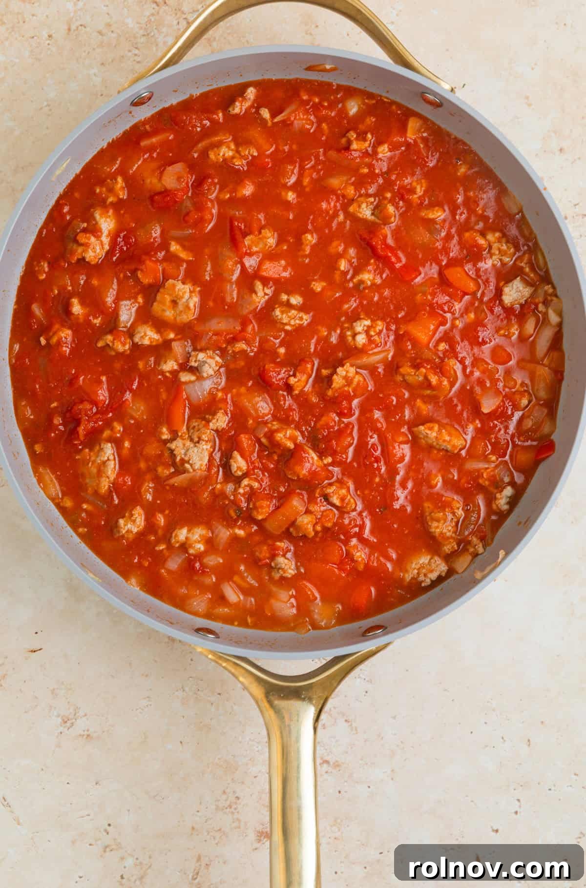 One-Pan Ravioli Lasagna 7 Marinara added to skillet with browned turkey and veggies.
