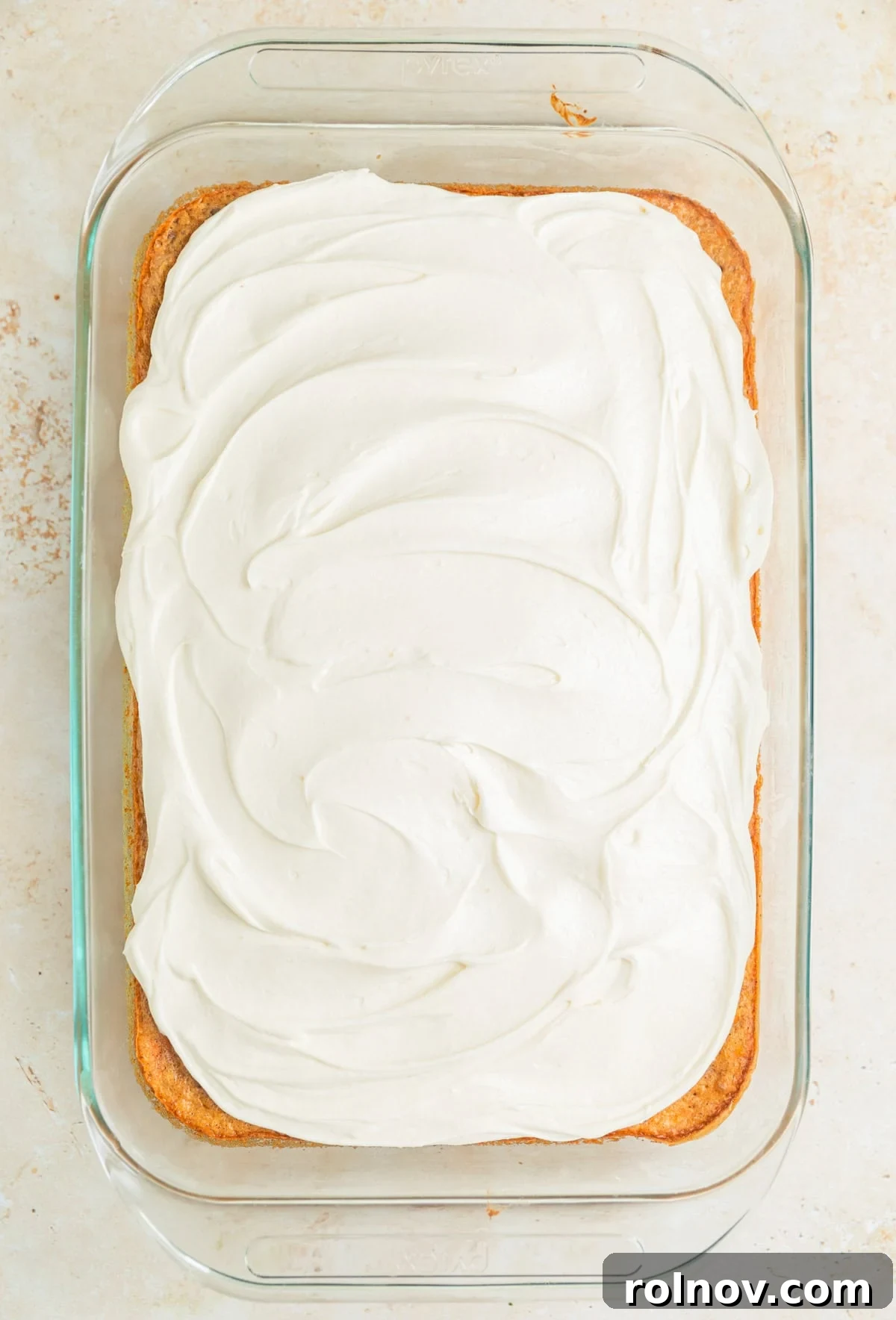 Foolproof Box Mix Carrot Cake 11 A beautifully iced carrot sheet cake in its baking pan, ready to be served or chilled.
