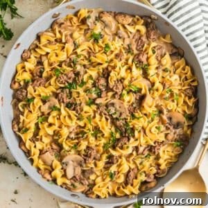 Skillet with beef stroganoff topped with chopped fresh parsley.