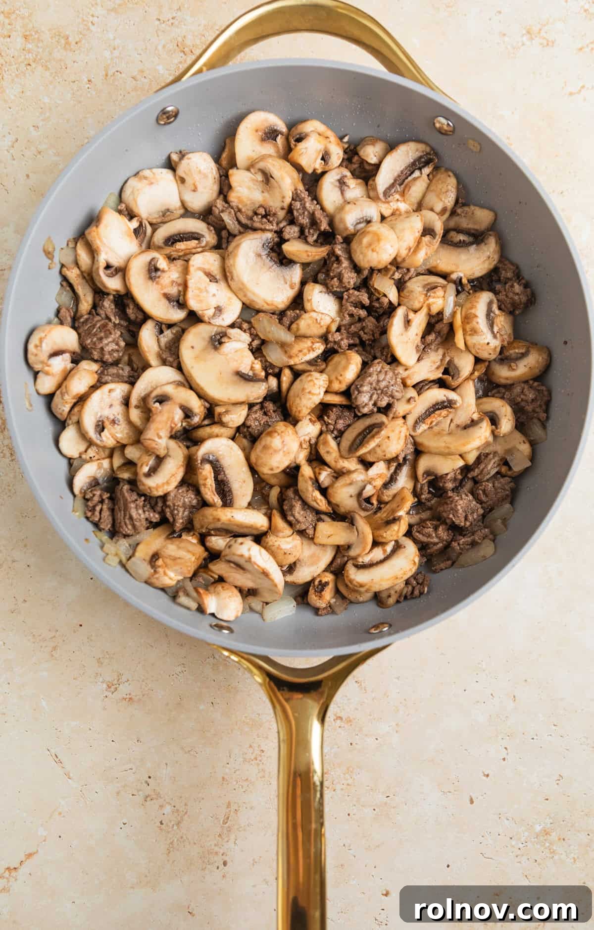 Creamy One-Pot Ground Beef Stroganoff 5 Mushrooms and browned ground beef in skillet.