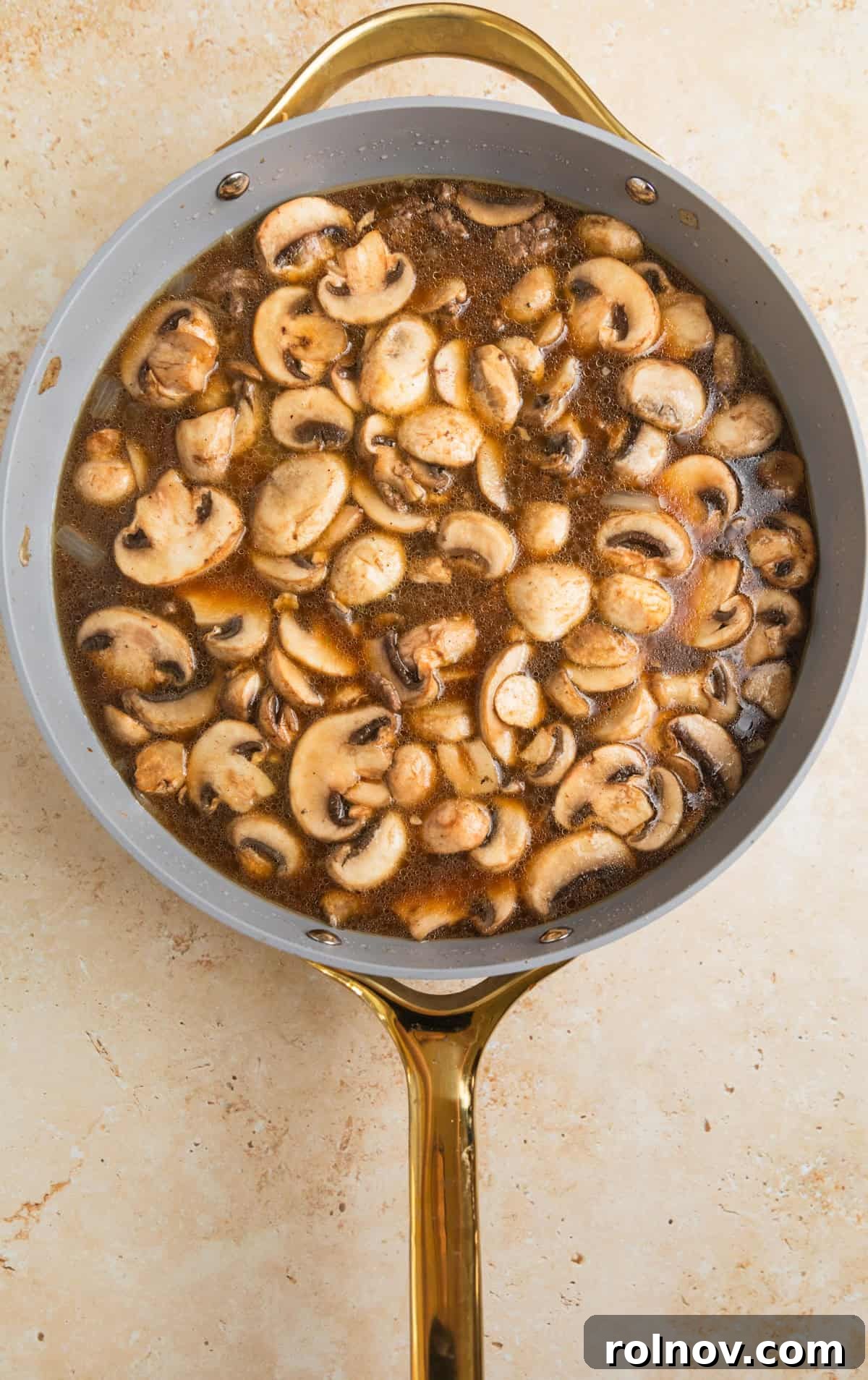 Creamy One-Pot Ground Beef Stroganoff 6 Broth added to skillet with beef and mushrooms.