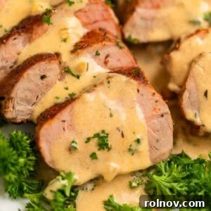 Seared Pork Tenderloin with Dijon Cream 10 Sliced pork tenderloin on plate covered with mustard sauce and chopped parsley.