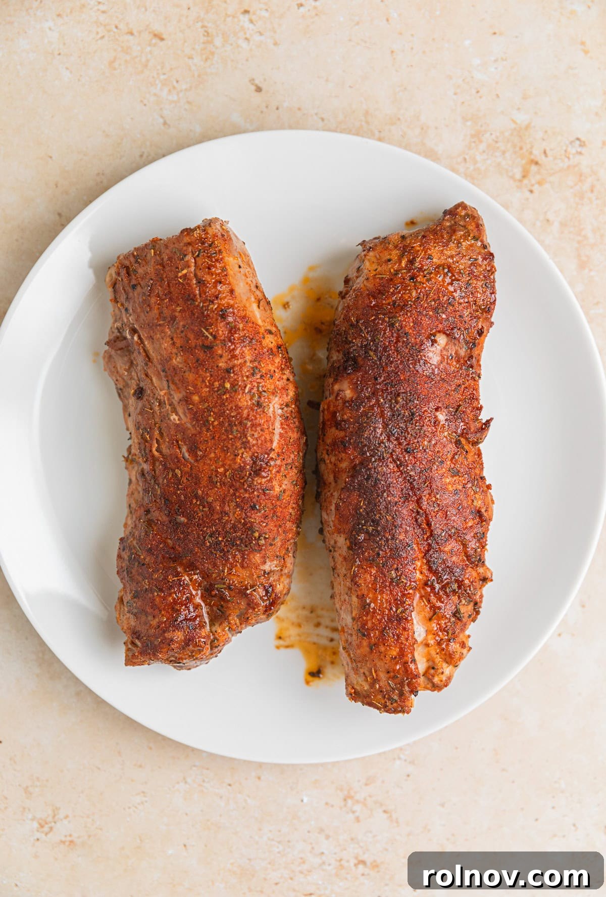 Seared Pork Tenderloin with Dijon Cream 7 Resting seared pork tenderloin on plate.