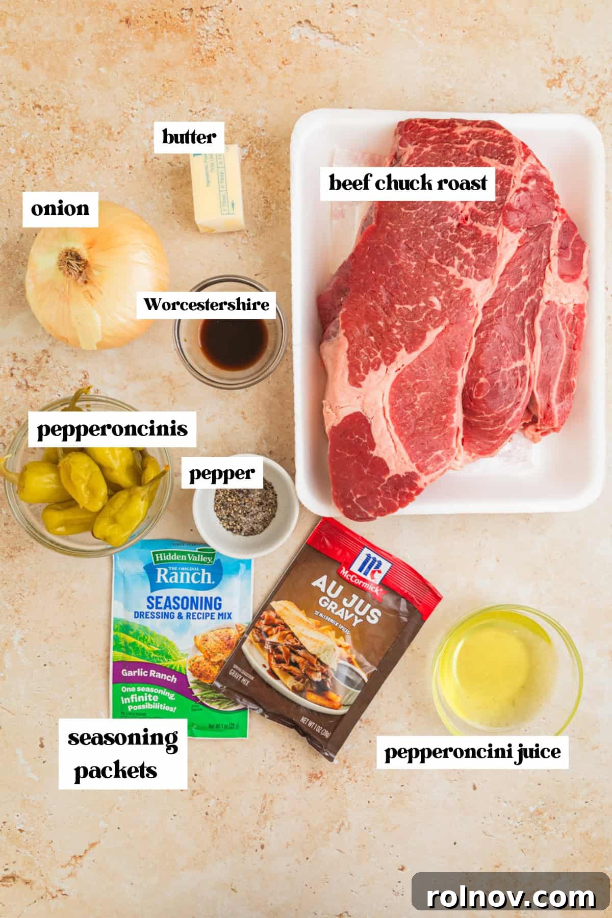 Melt-in-Your-Mouth Mississippi Pot Roast 3 Chuck roast, onion, peppers, and other ingredients to make recipe arranged on surface.
