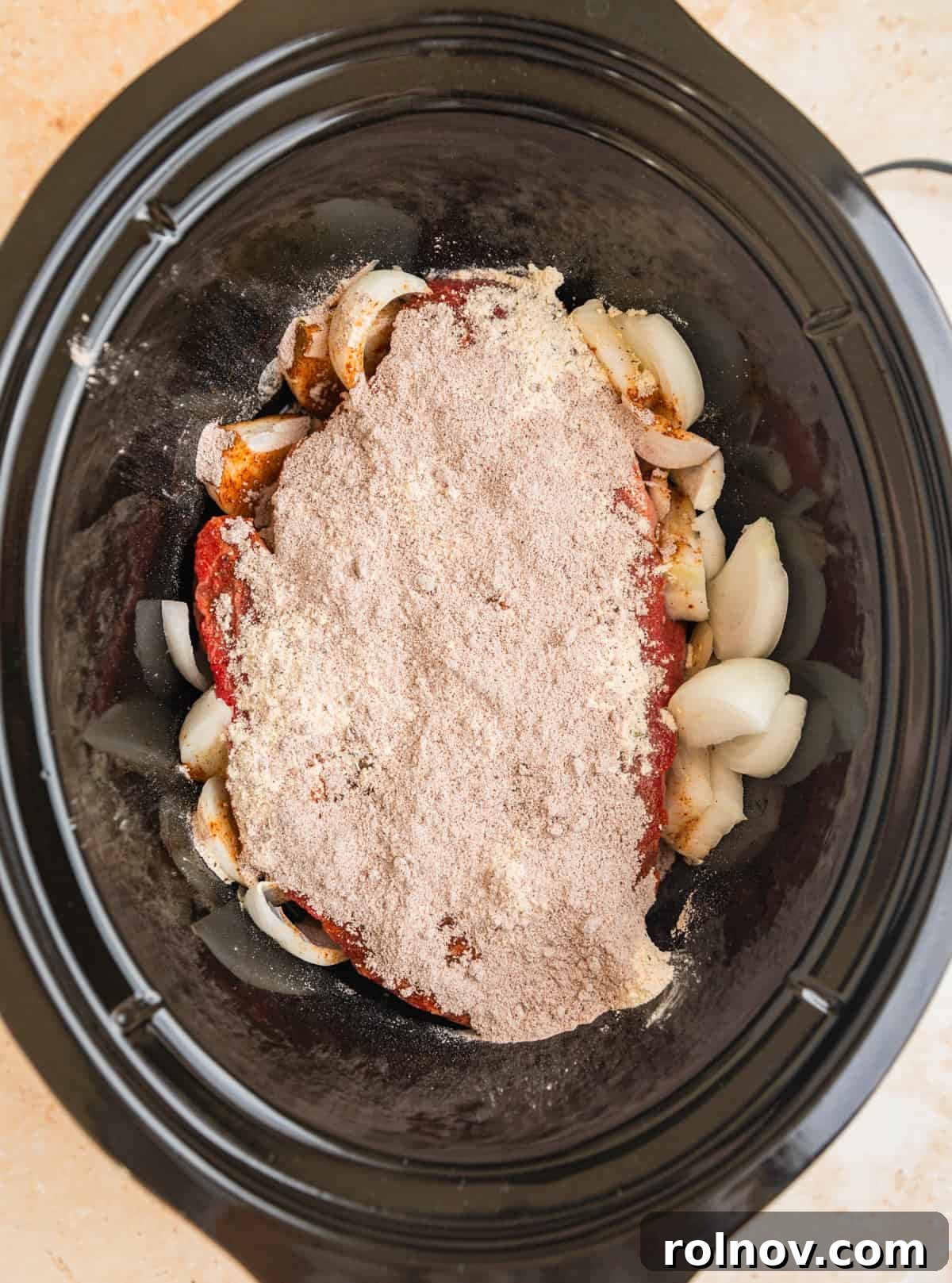 Melt-in-Your-Mouth Mississippi Pot Roast 4 Chuck roast in crock pot with sliced onions, ranch seasoning and au jus seasoning.