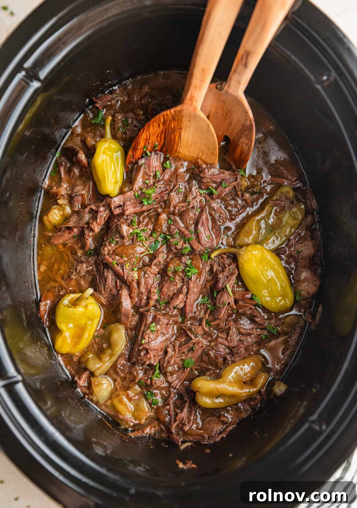 Melt-in-Your-Mouth Mississippi Pot Roast 7 Crock pot Mississippi pot roast in crockpot with spoons.