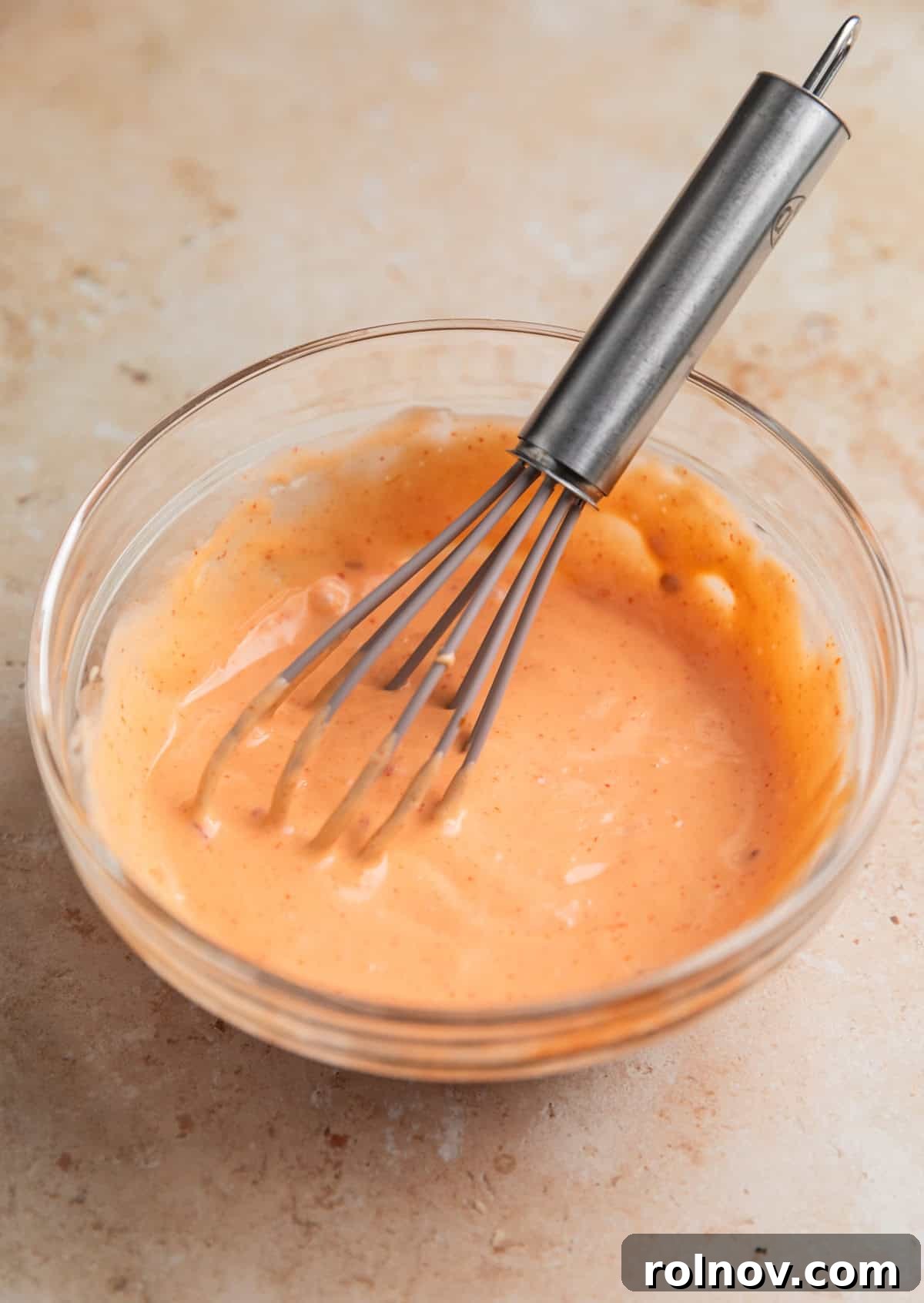 Crispy Air Fryer Salmon Bites 9 Whisk in stirred bang bang sauce in small glass dish.