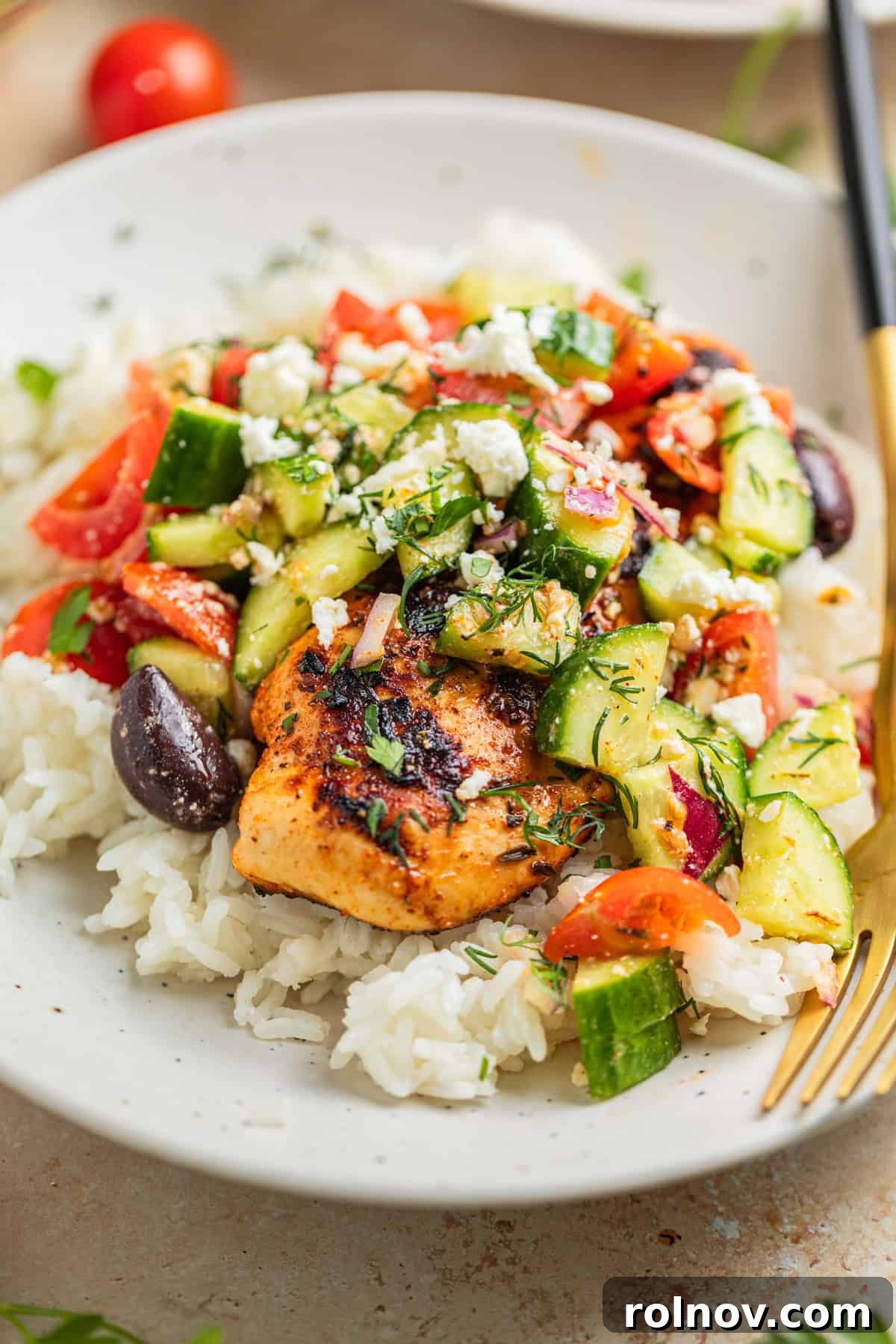 Grilled marinated mediterranean chicken on rice topped with greek cucumber salad.