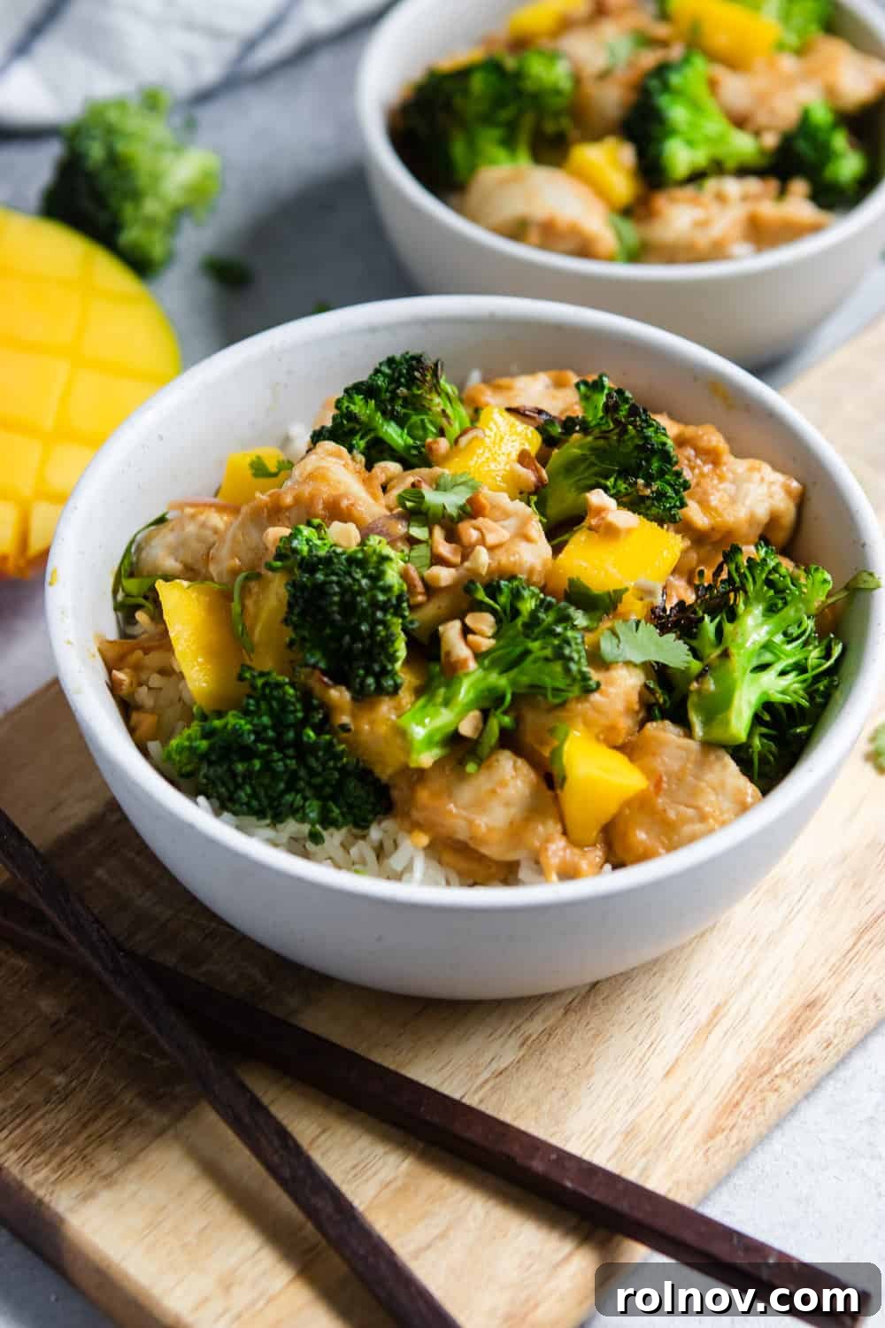 Exotic Mango Peanut Chicken Stir Fry 3 Close-up of Peanut Mango Chicken and Broccoli Stir Fry in a bowl, showing vibrant colors and textures.