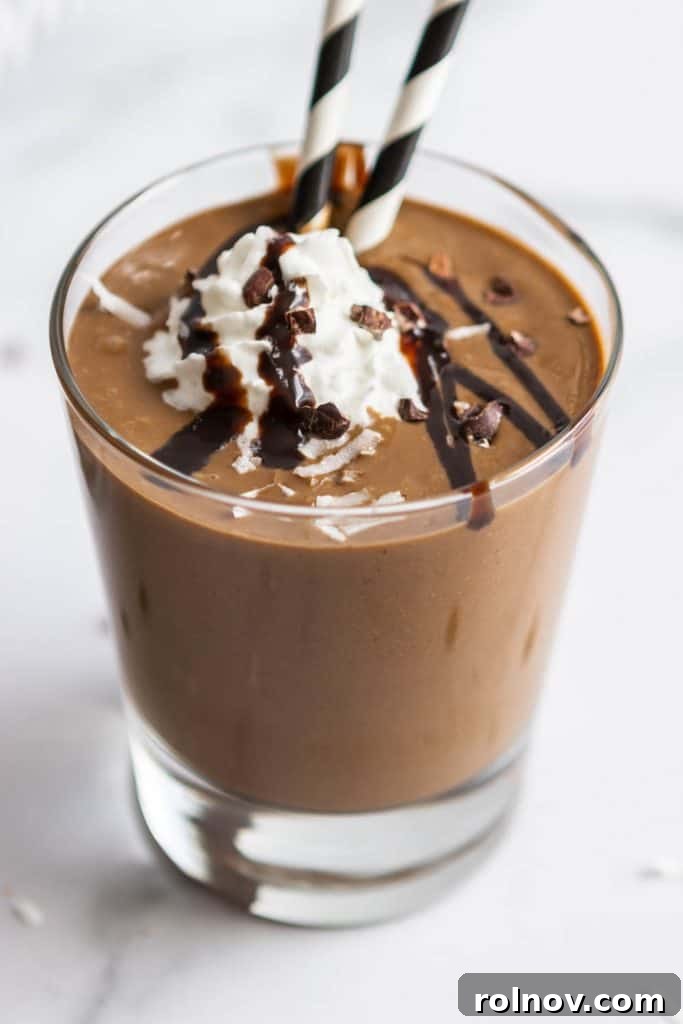 Close-up of a Chocolate Coconut Smoothie in a tall glass, showing its creamy texture.