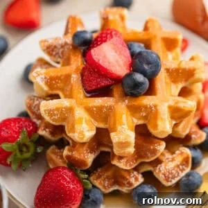 Cottage Cloud Waffles 8 Cottage cheese waffles stacked on plate with berries, ready to serve.