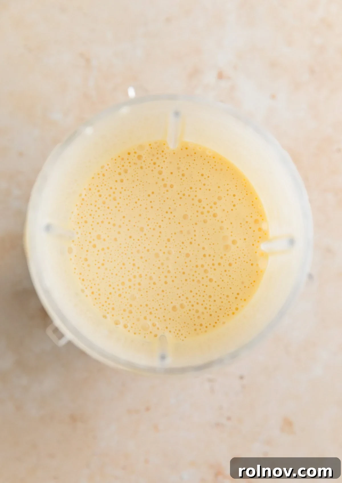 Cottage Cloud Waffles 4 Blended eggs and cottage cheese in a blender cup, creating a smooth mixture.