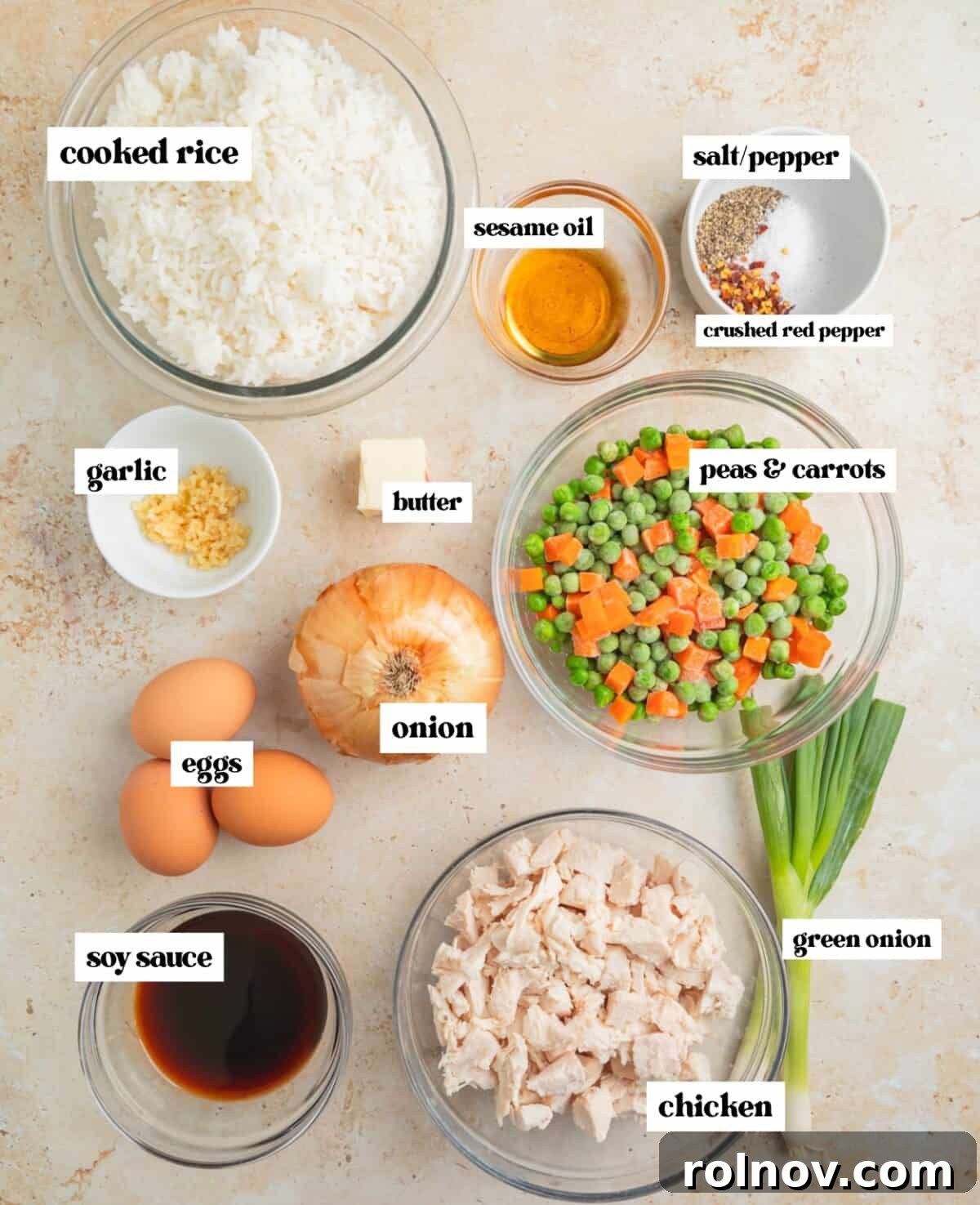 Quick Homestyle Chicken Fried Rice 3 Cooked white rice, frozen peas and carrots, soy sauce, sesame oil, and whisked eggs arranged on a kitchen surface and clearly labeled for fried rice preparation.