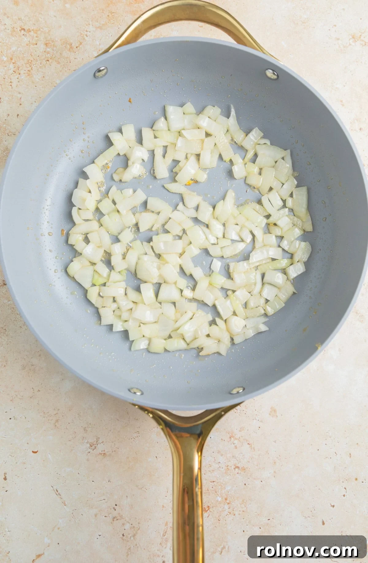 Quick Homestyle Chicken Fried Rice 5 Diced onions sautéing in a large skillet with sesame oil until translucent.