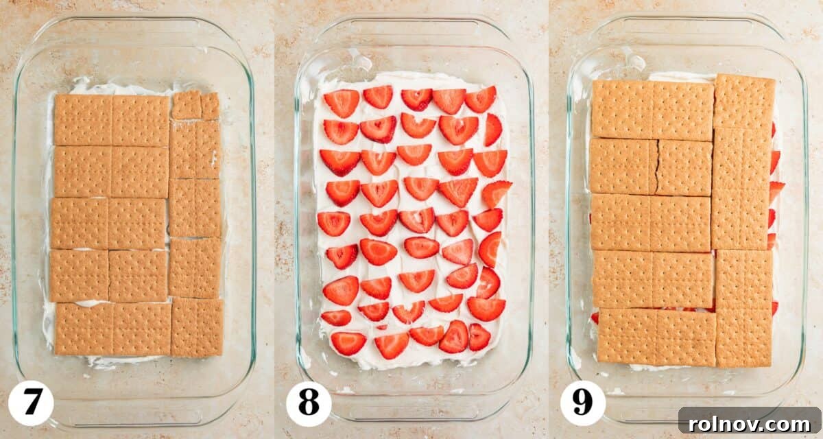 No-Bake Strawberry Dream Cake 6 Step-by-step layering of the icebox cake, showing a neat row of graham crackers, followed by a generous layer of cream cheese whipped cream, and then freshly sliced strawberries, ready for the next layer.