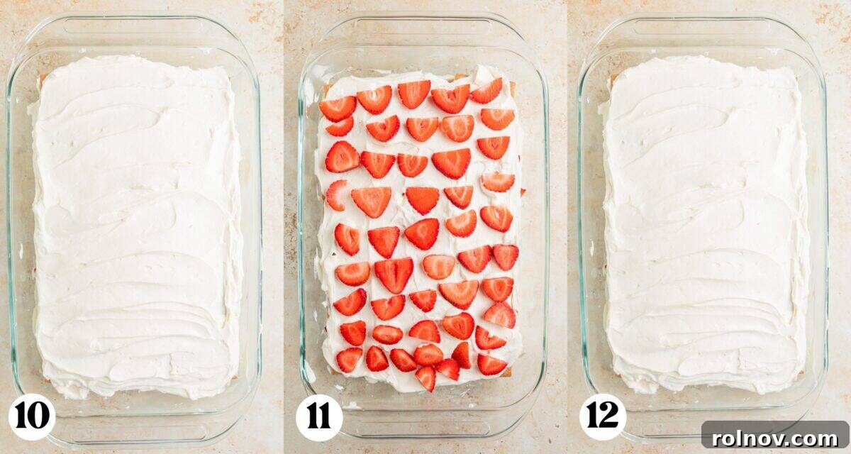 No-Bake Strawberry Dream Cake 7 The assembly continues with another smooth layer of cream cheese whipped cream spread over graham crackers, followed by an even distribution of fresh strawberries, and preparation for the final creamy layer.