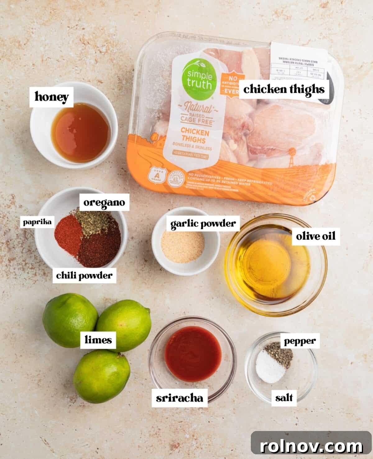 Honey, limes, chicken thighs, and other ingredients labeled on surface.