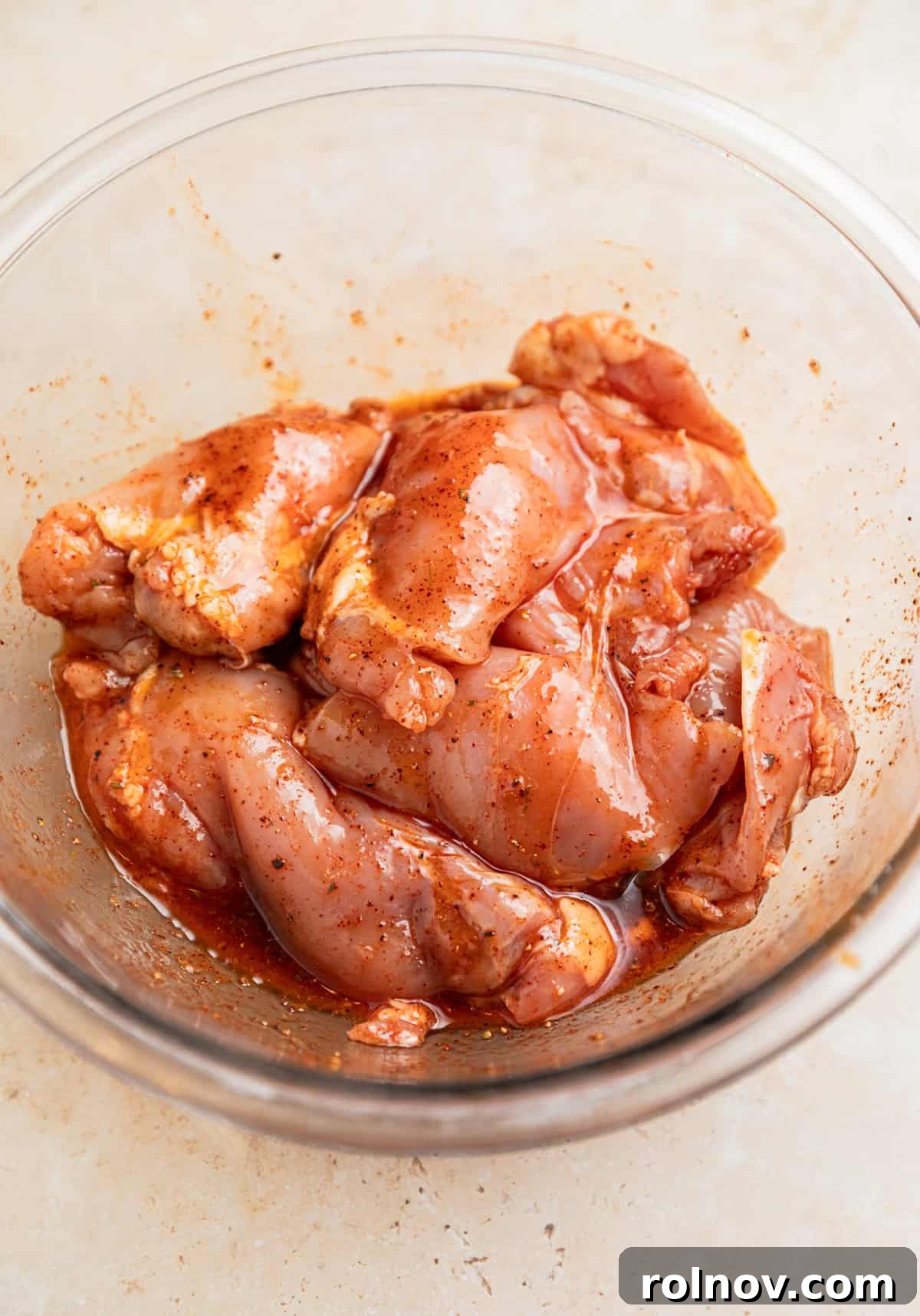 Chicken thighs in bowl with marinade.