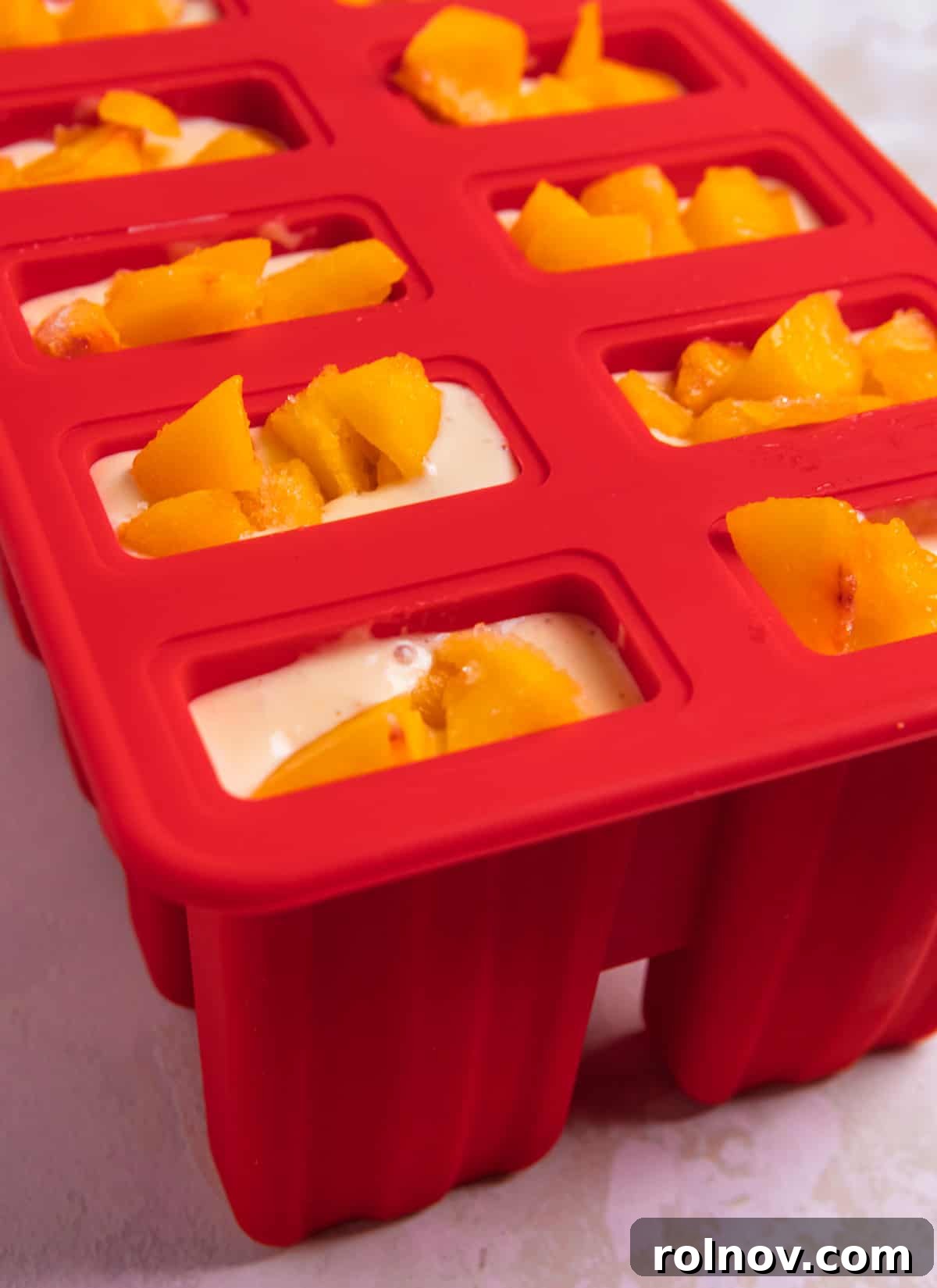 Peaches & Cream Pops 5 Popsicle molds filled with mixture and topped with peaches.