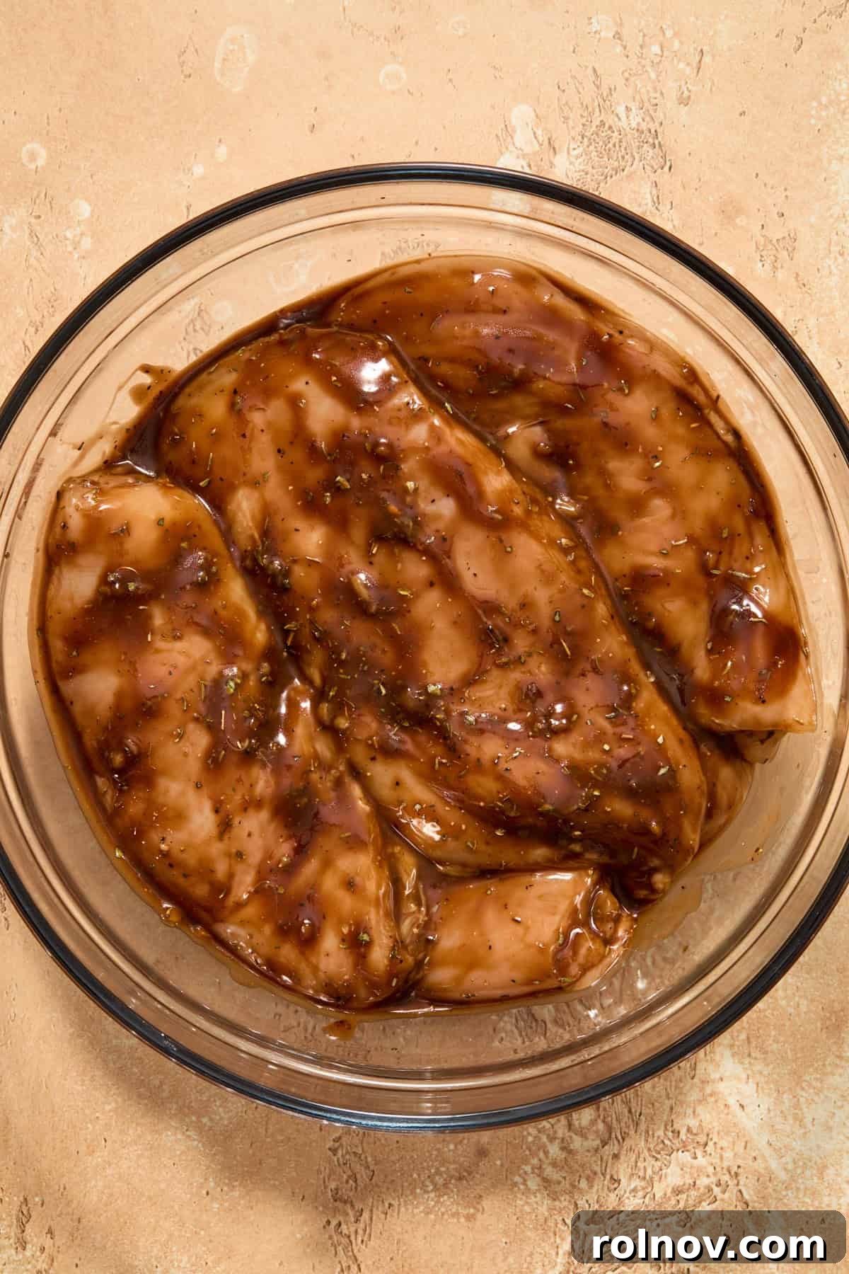 Grilled Balsamic Glazed Chicken Breast 6 Bowl with chicken breast sitting in balsamic marinade.