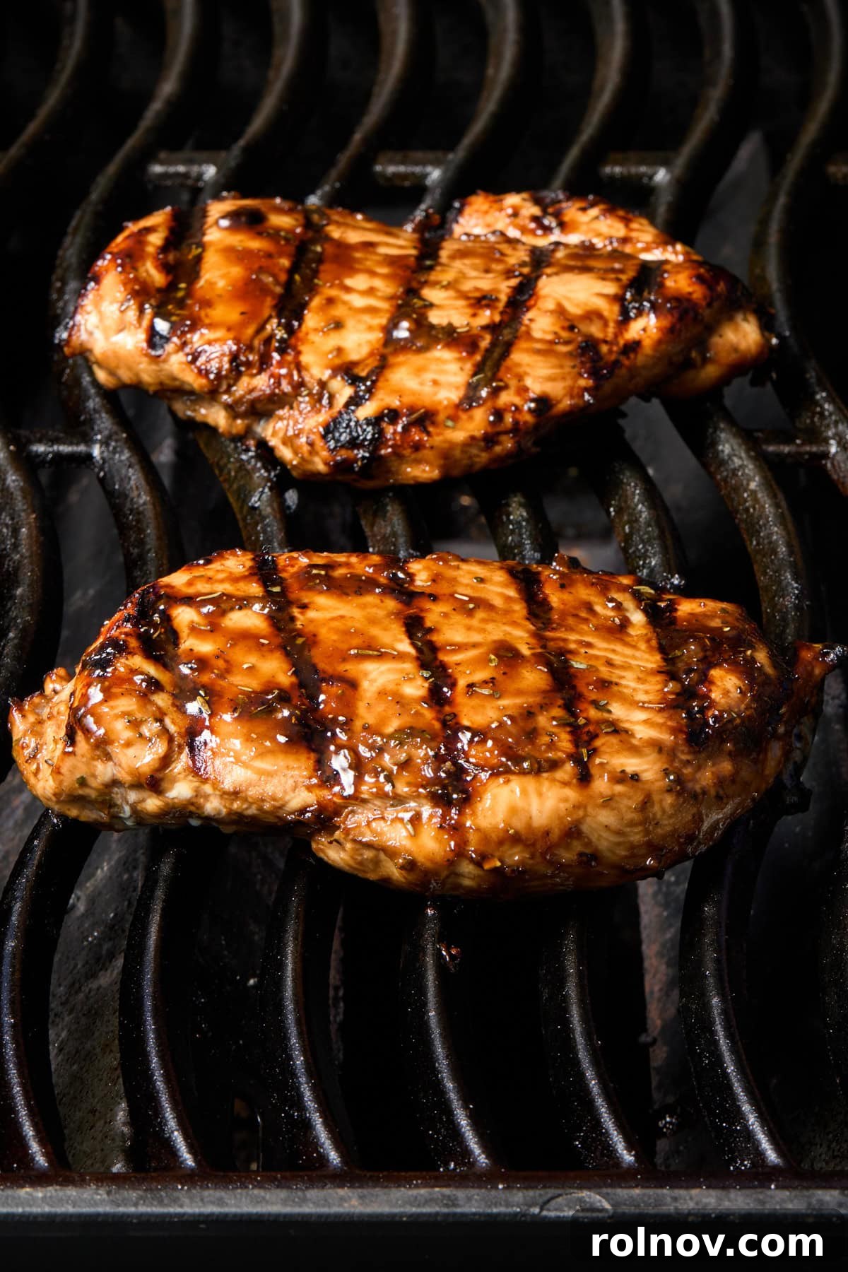Grilled Balsamic Glazed Chicken Breast 8 Chicken on grill with marinade brushed over top.