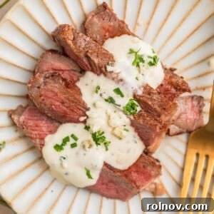 Ribeye Perfection with Gorgonzola Cream 11 Sliced grilled ribeye steak sliced and served on plate with gorgonzola sauce.