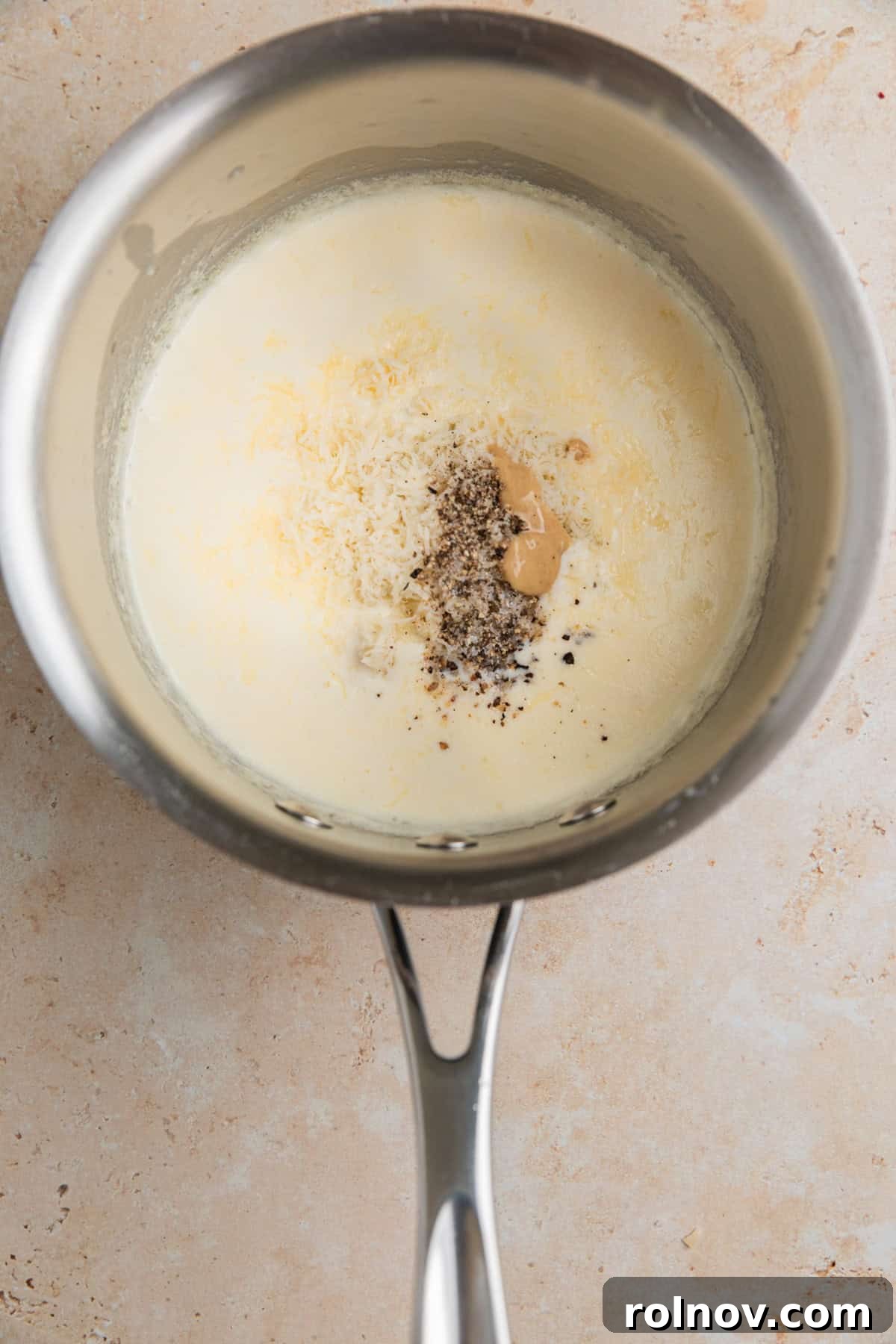 Ribeye Perfection with Gorgonzola Cream 6 Parmesan, gorgonzola and other ingredients added to sauce pan with cream.