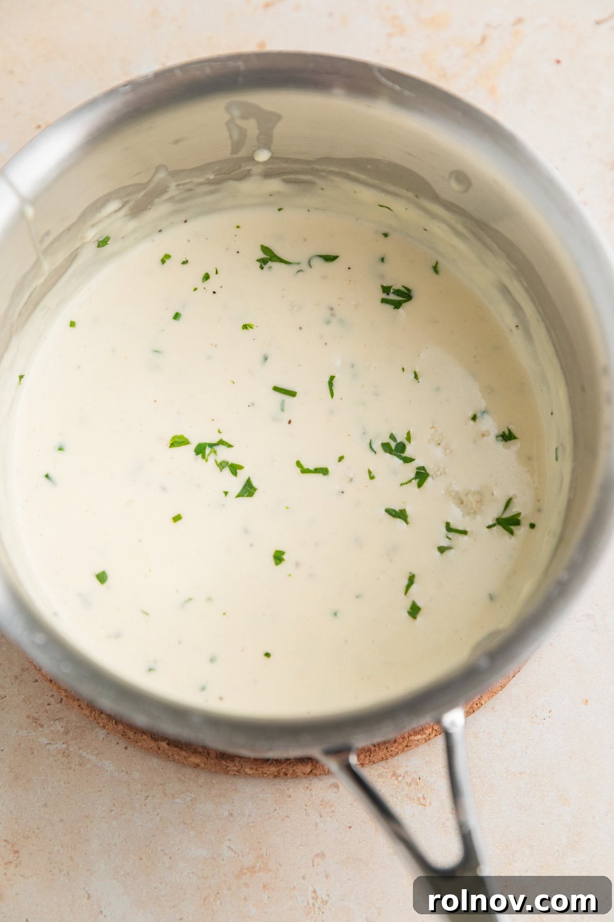 Ribeye Perfection with Gorgonzola Cream 7 Gorgonzola sauce in pan topped with chopped parsley and chives.