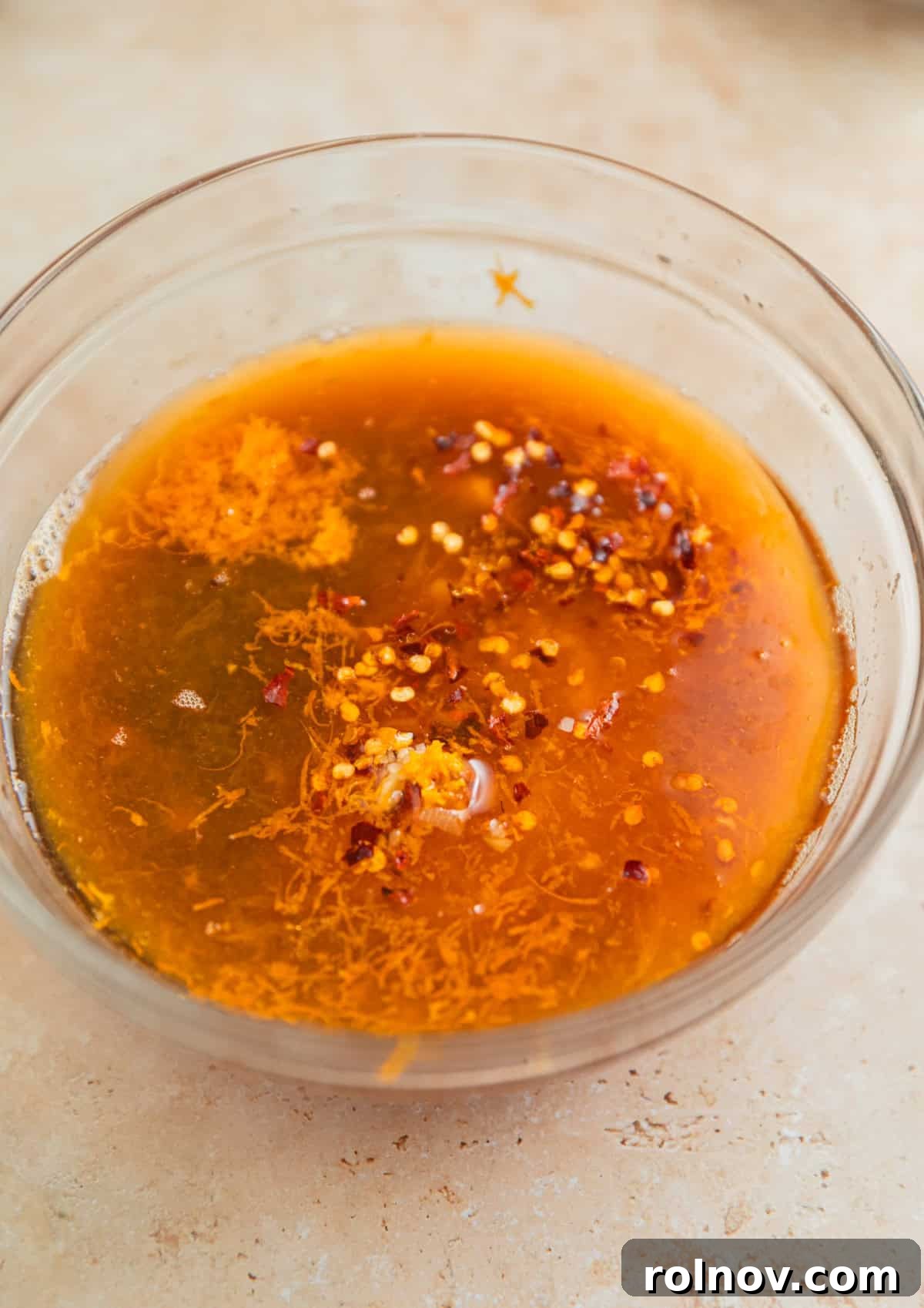 Zesty Slow Cooker Orange Chicken 4 All orange sauce ingredients neatly placed in a glass bowl, ready to be mixed for the crockpot orange chicken.